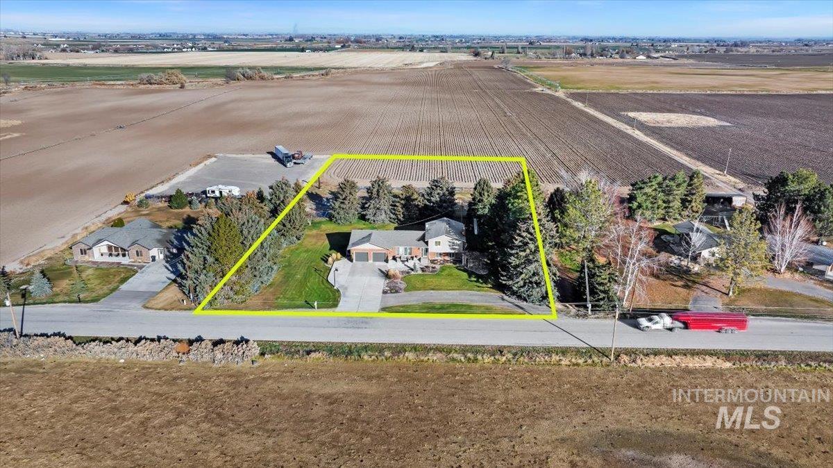 Aerial view of sparsely populated area featuring property parcel outlined and abundant farmland