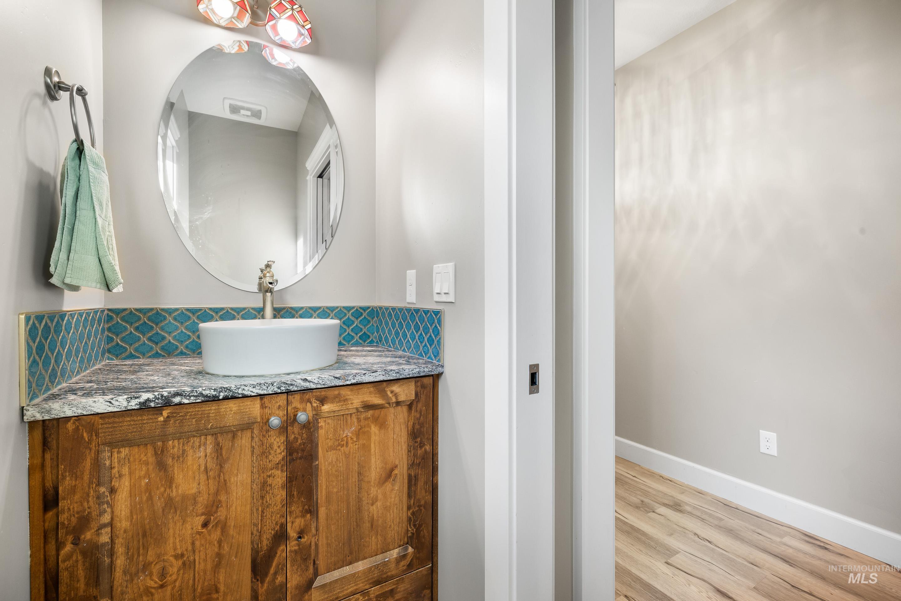 Bathroom featuring vanity and light wood-style floors