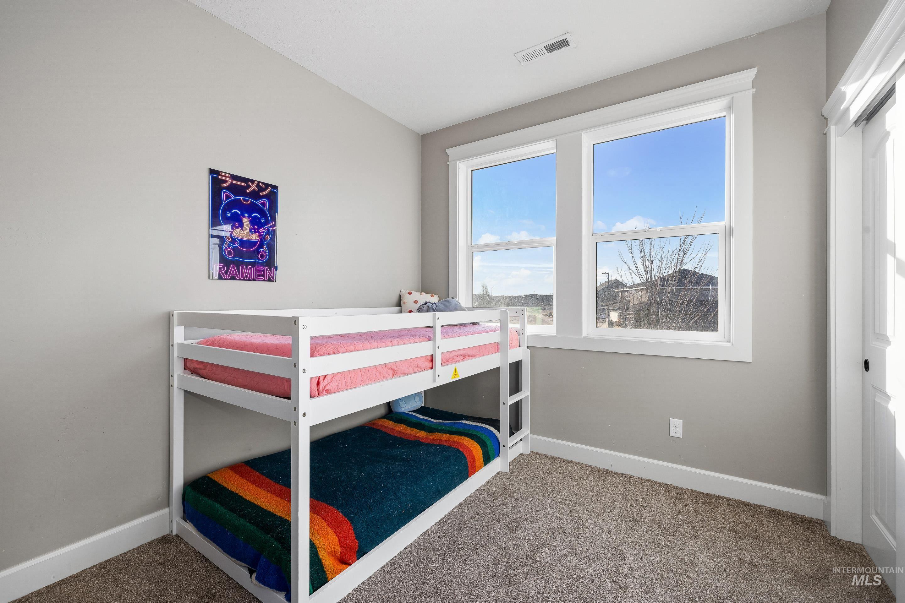 Bedroom featuring light carpet
