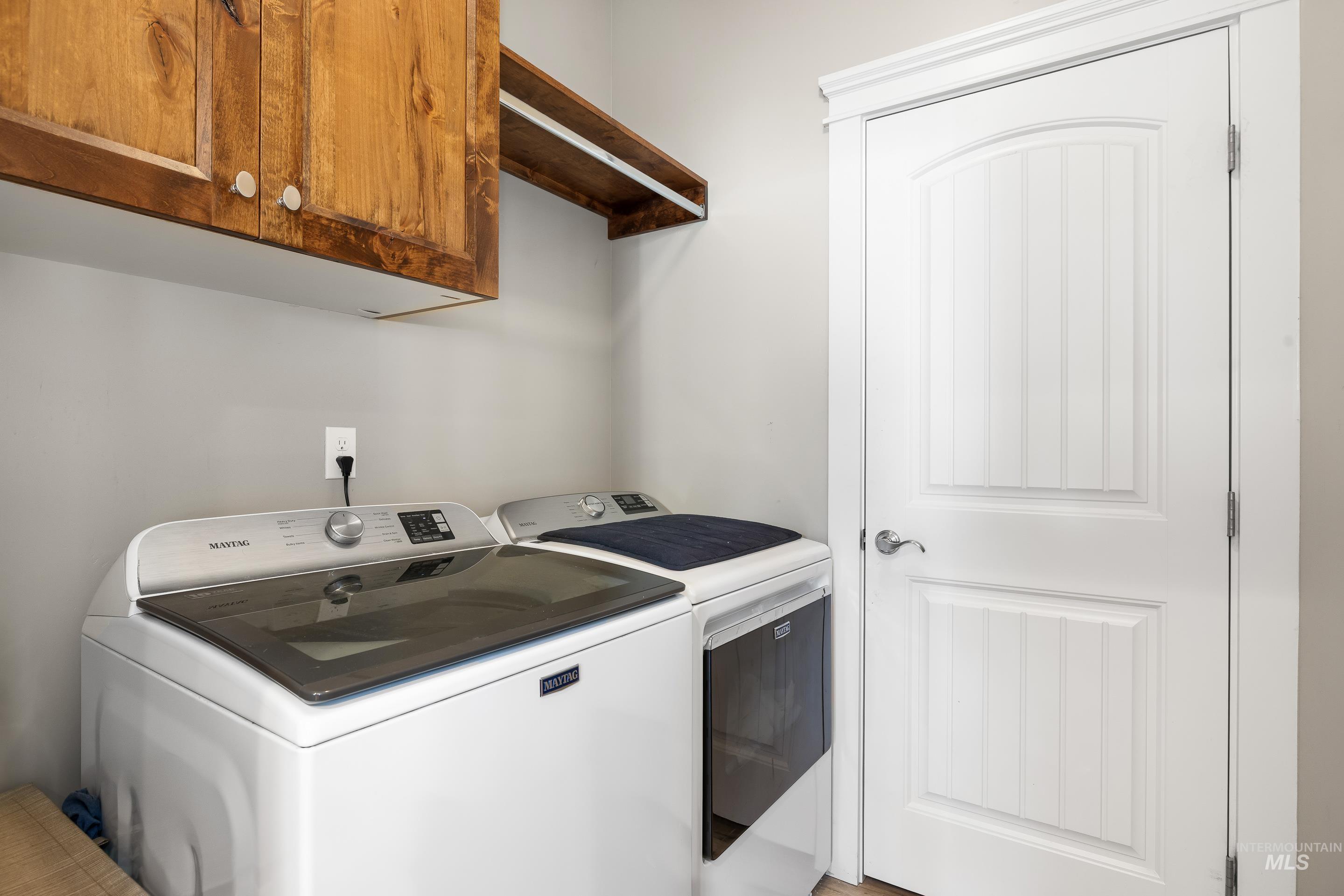 Washroom with cabinet space and independent washer and dryer