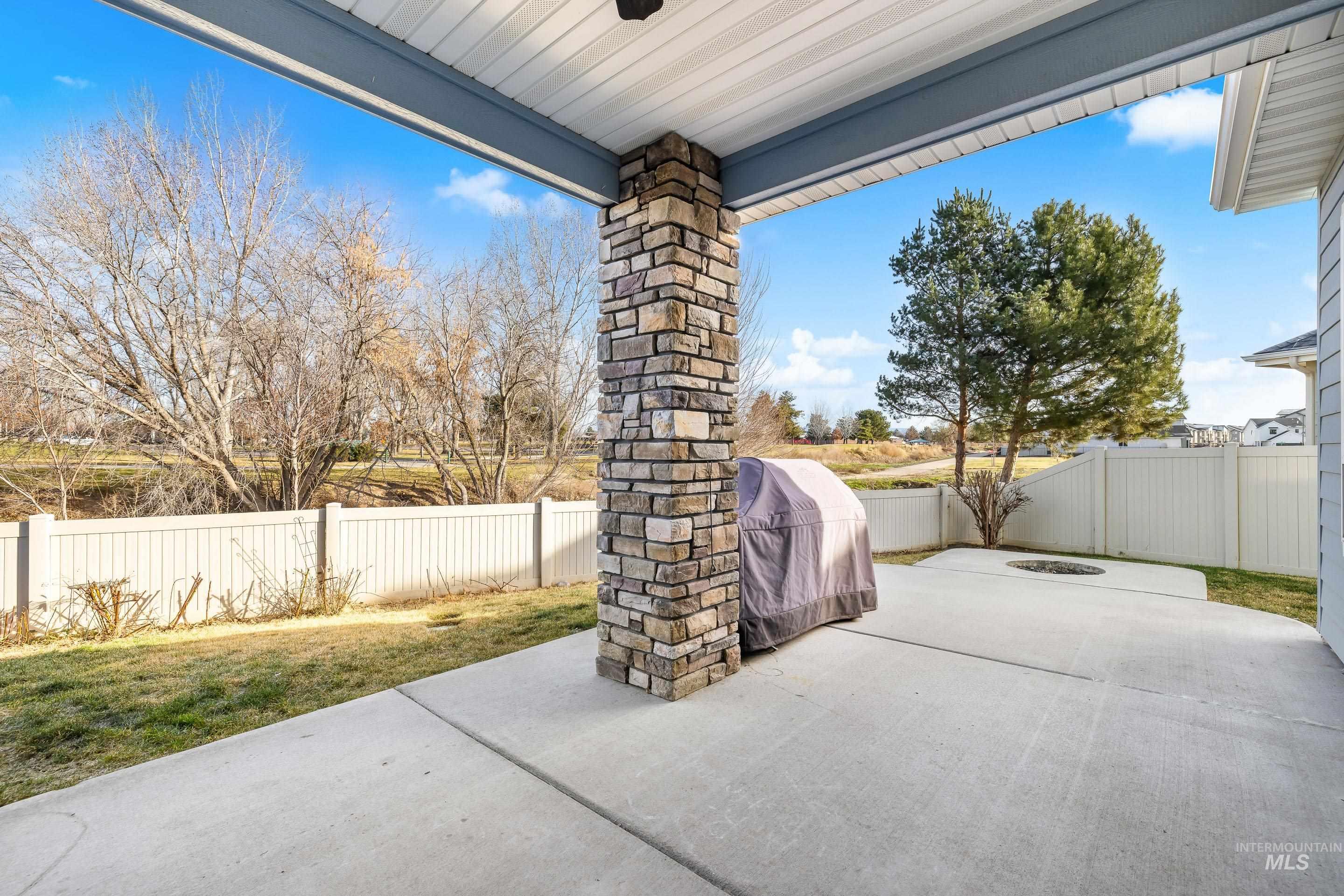 Fenced backyard featuring a grill and a patio