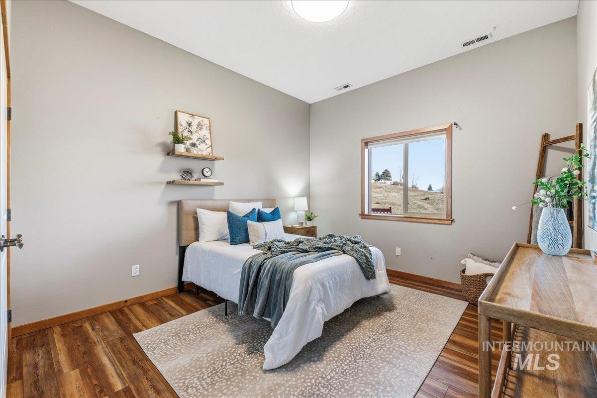 Bedroom with baseboards and wood finished floors