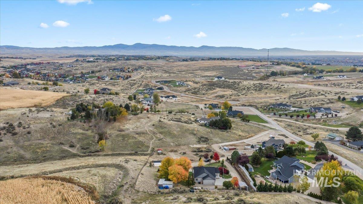 Aerial view of property's location with mountains and rural landscape