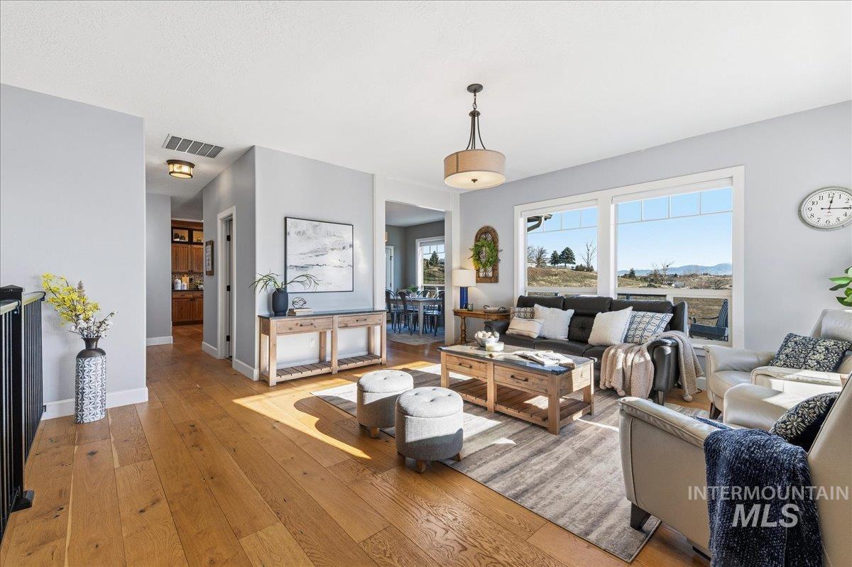 Living area with light wood finished floors and baseboards