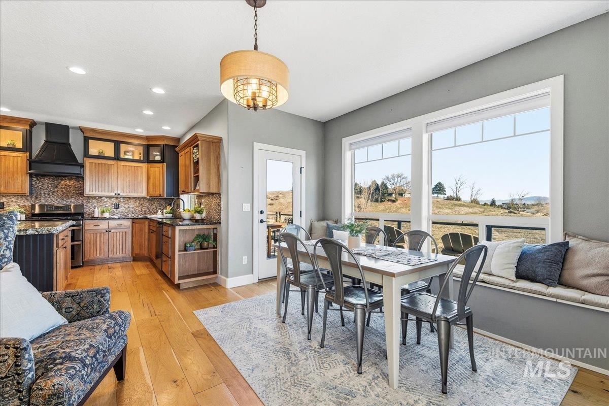 Dining area with light wood-style flooring and recessed lighting