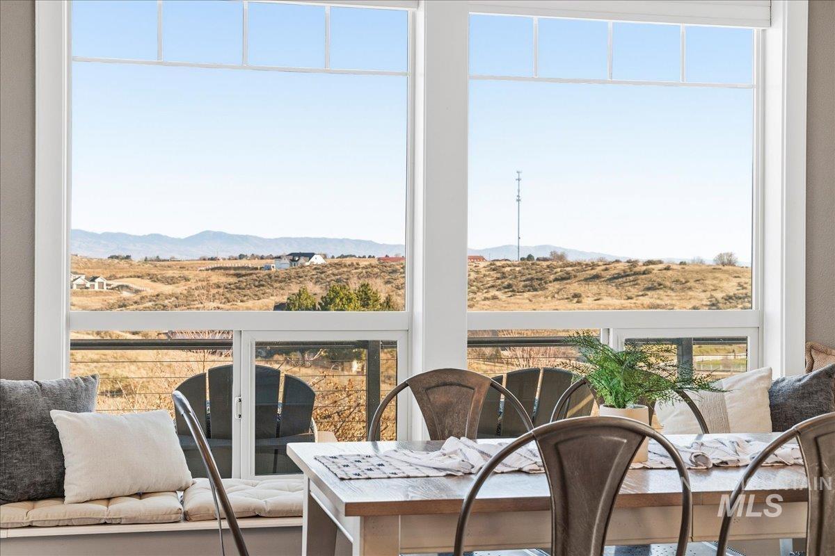 Sunroom featuring a mountain view and a view of countryside