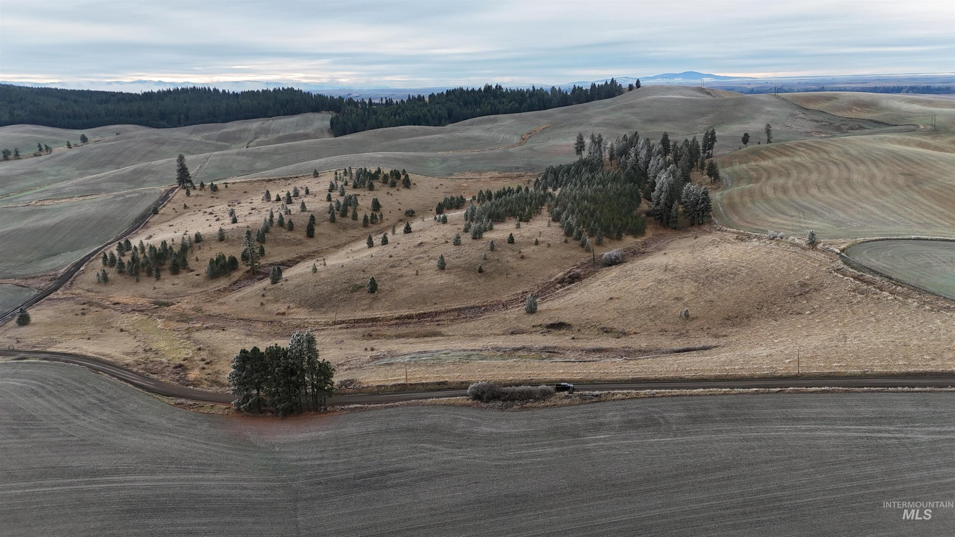 Aerial view of property and surrounding area featuring mountains