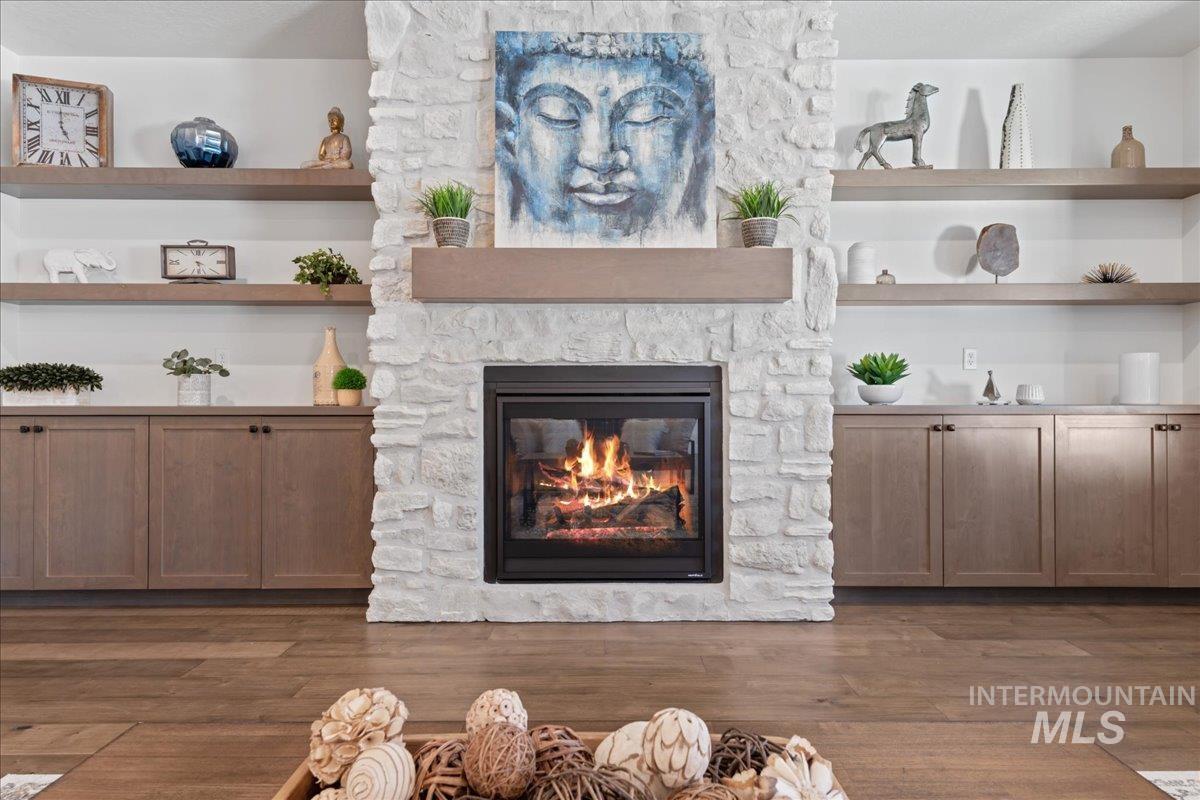 Detailed view of a stone fireplace and wood finished floors