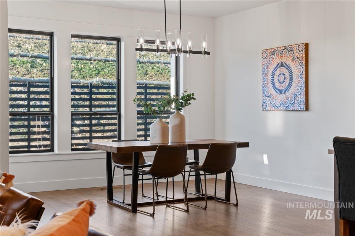 Dining area with light wood-style floors and a chandelier