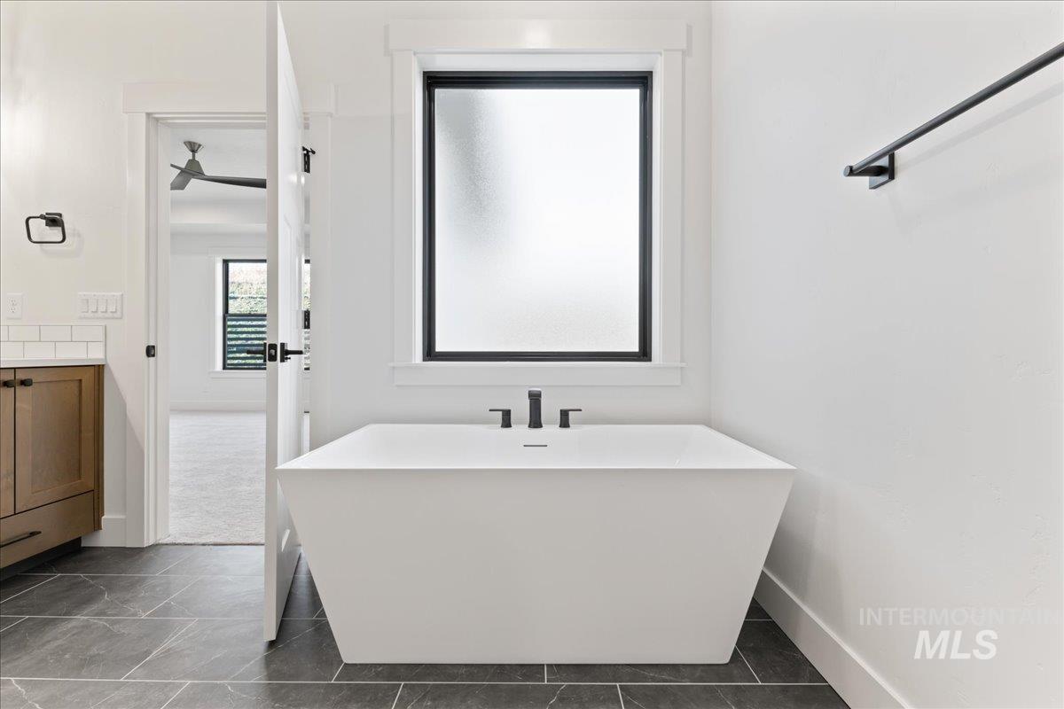 Full bath featuring a freestanding bath and vanity