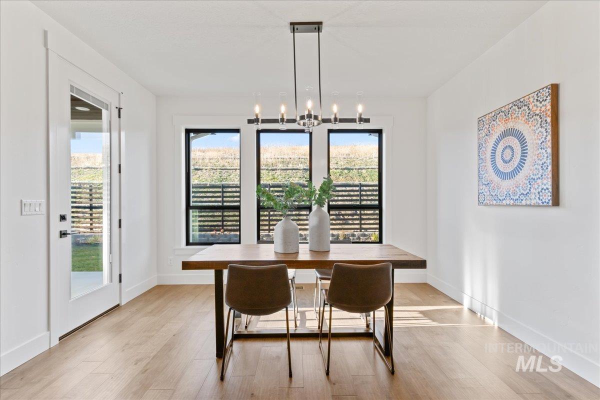 Dining area with light wood finished floors and a chandelier