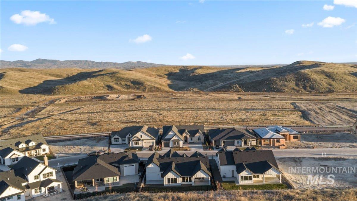 Aerial perspective of suburban area featuring a mountain backdrop
