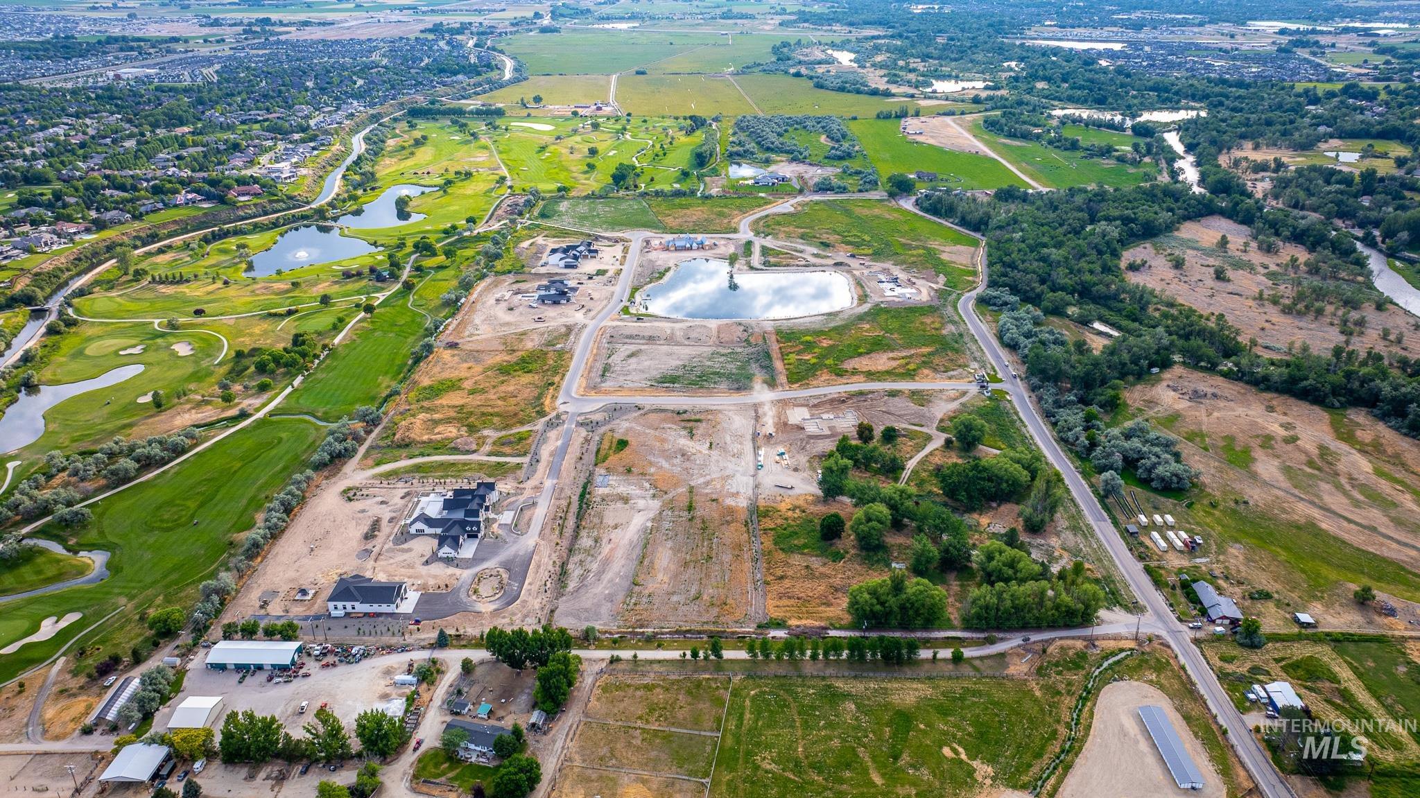 Aerial view of property and surrounding area with a large body of water and a golf course