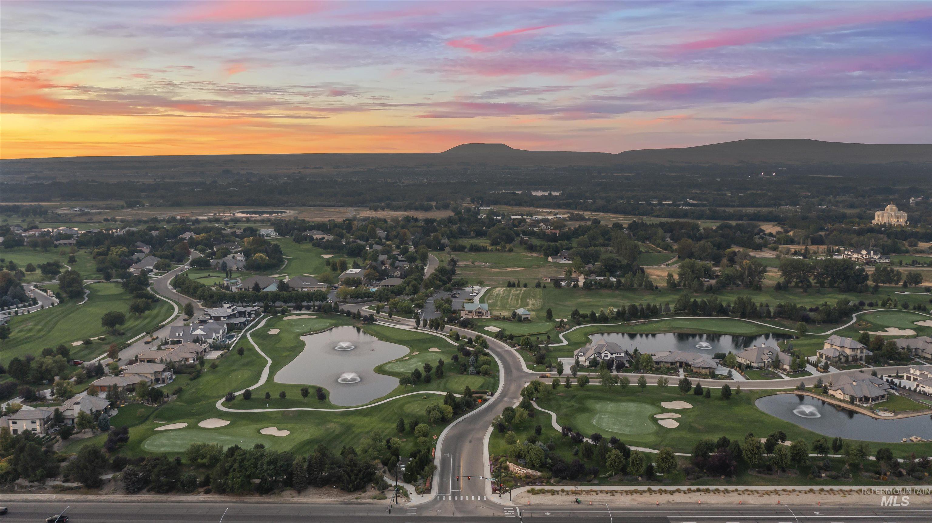 Aerial overview of property's location with a water and mountain view and a golf club
