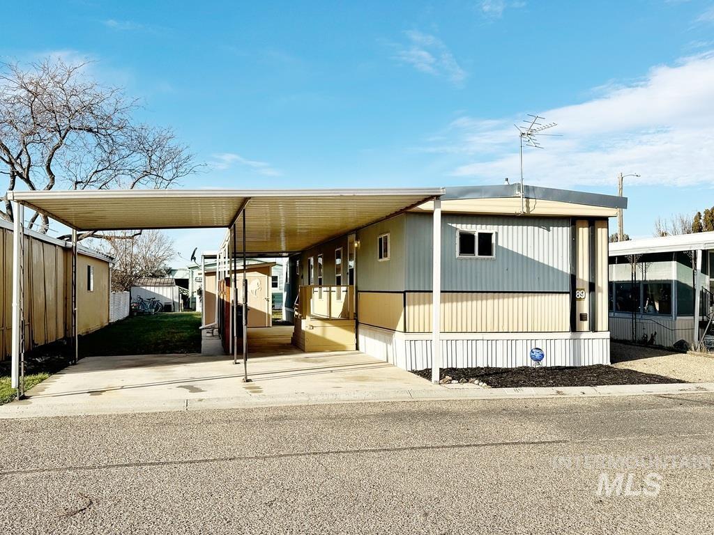 Manufactured / mobile home with an attached carport and driveway