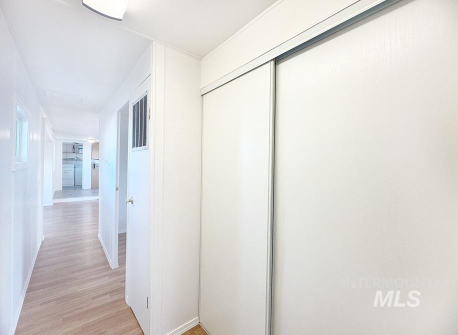 Corridor with light wood finished floors