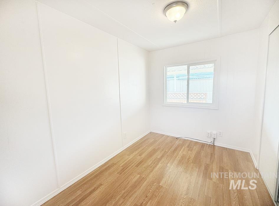 Empty room featuring light wood-style floors and baseboards