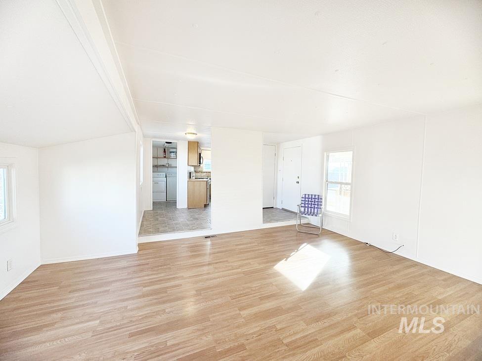 Unfurnished living room with light wood-style floors