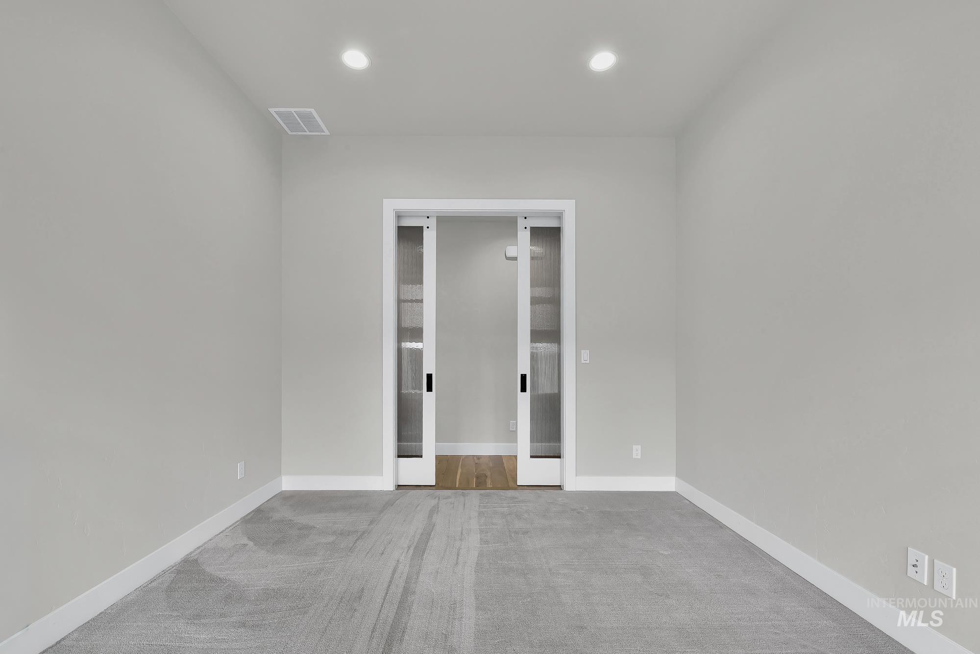 Unfurnished room featuring carpet flooring and recessed lighting