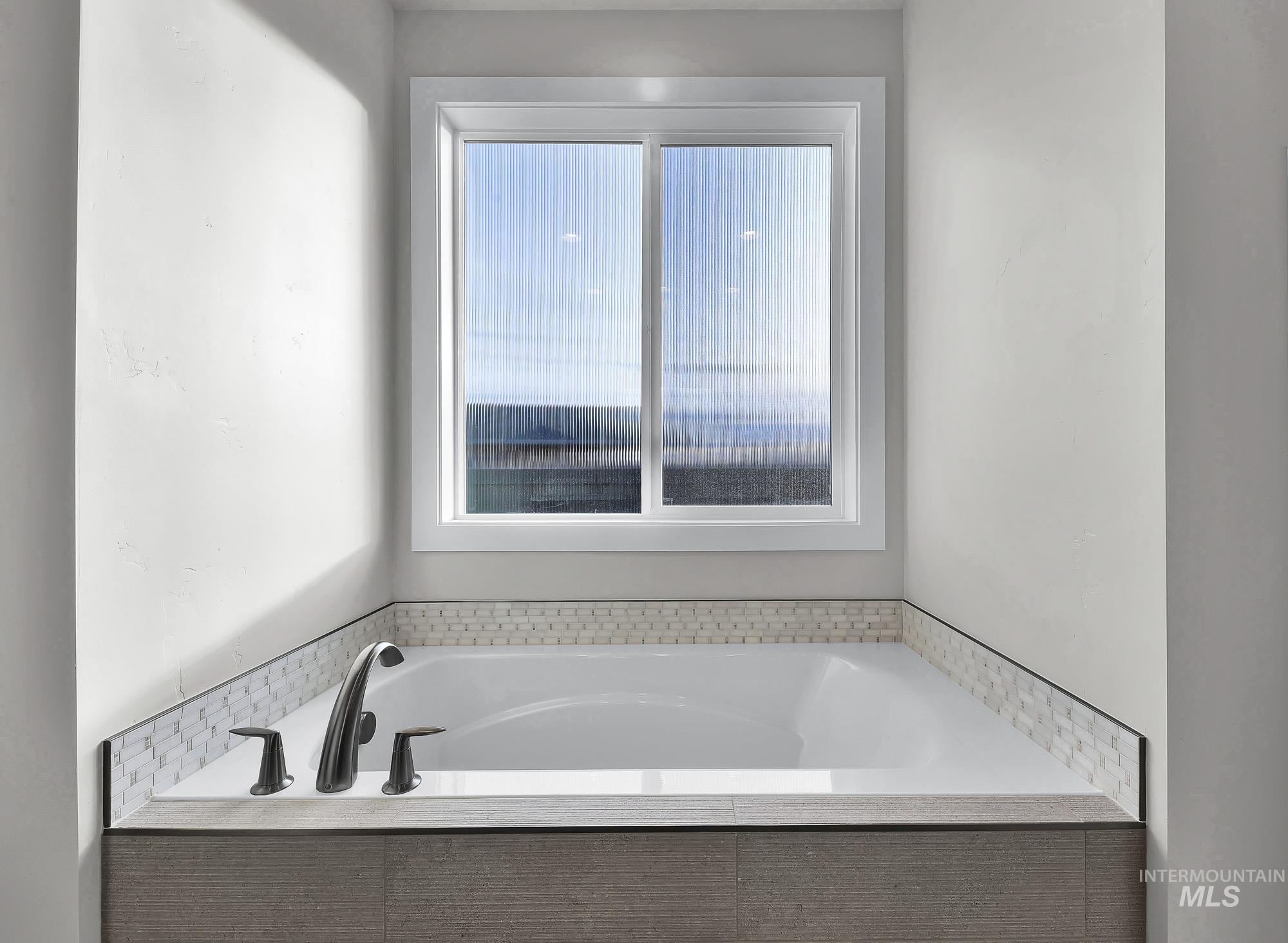 Full bathroom featuring a bath