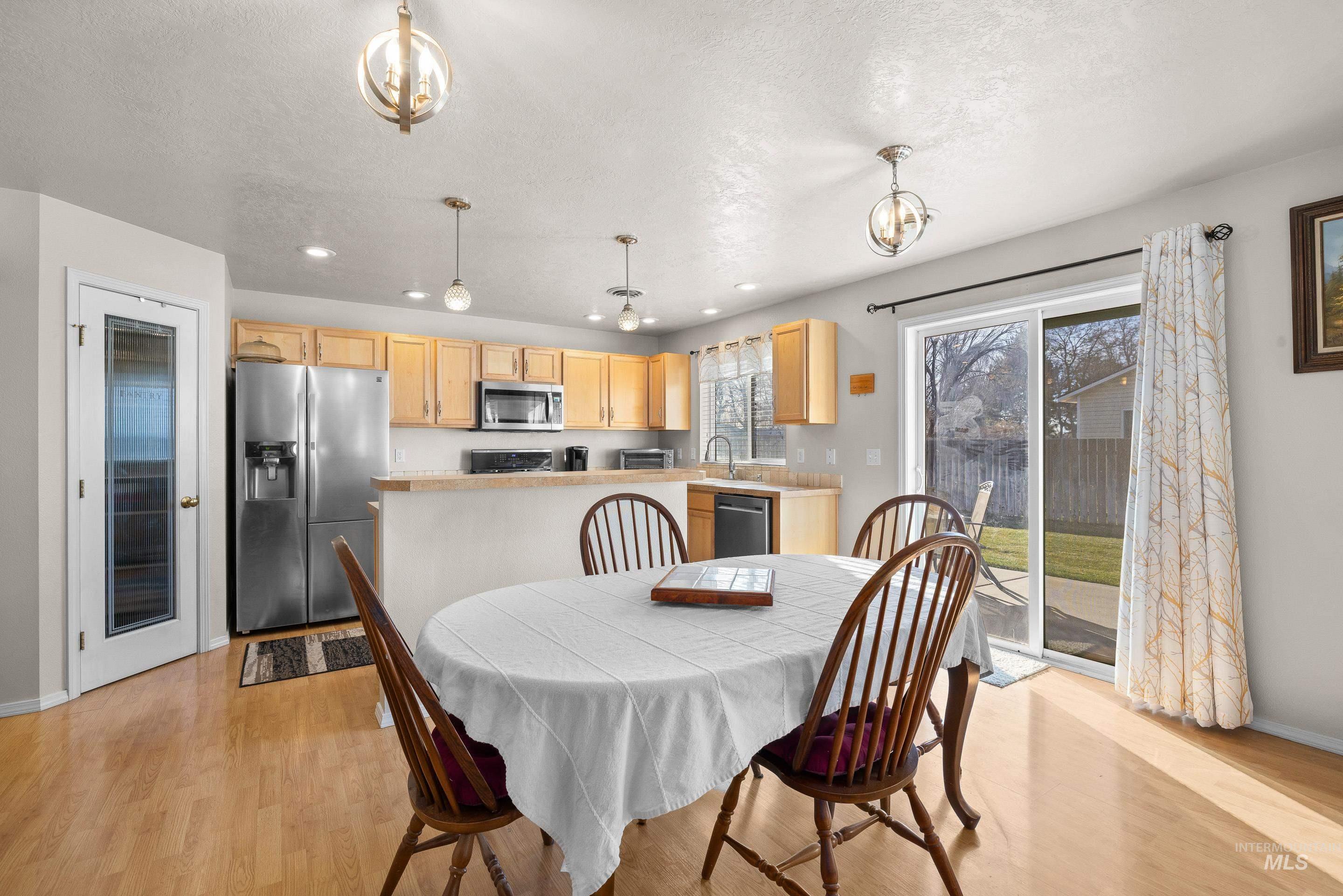 Dining space with recessed lighting and light wood-type flooring