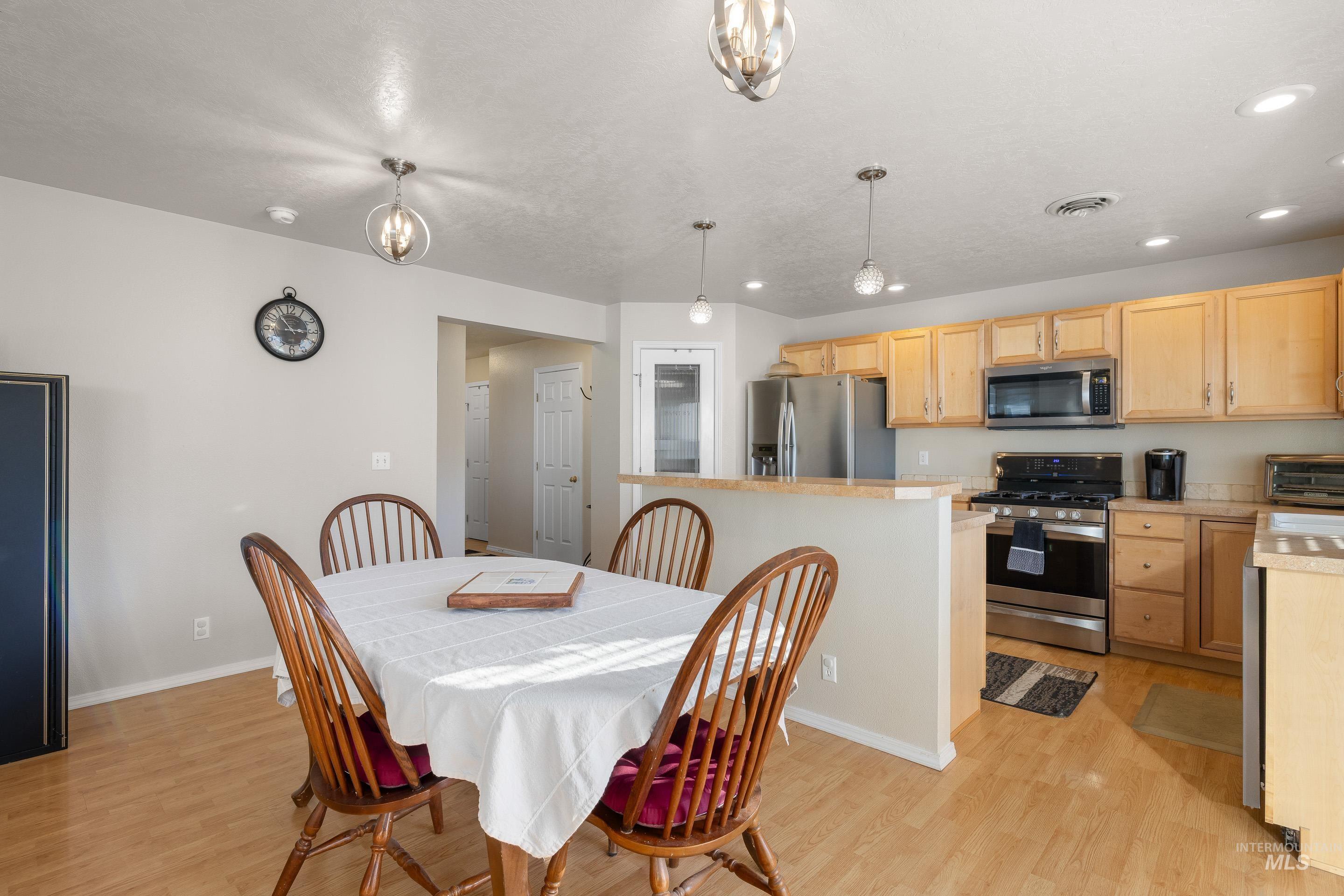 Dining room featuring light wood finished floors and recessed lighting