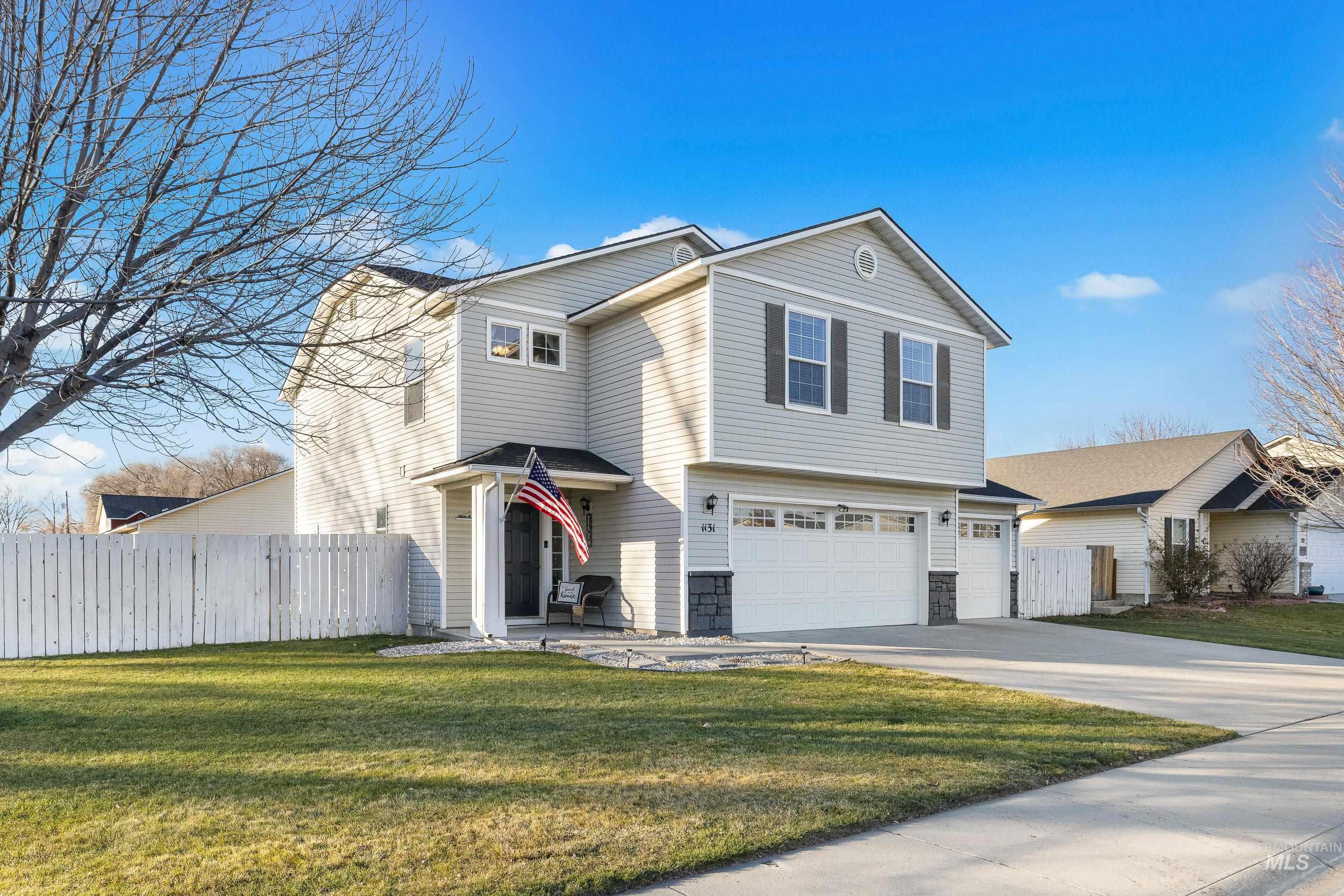 Traditional-style home featuring a garage and concrete driveway
