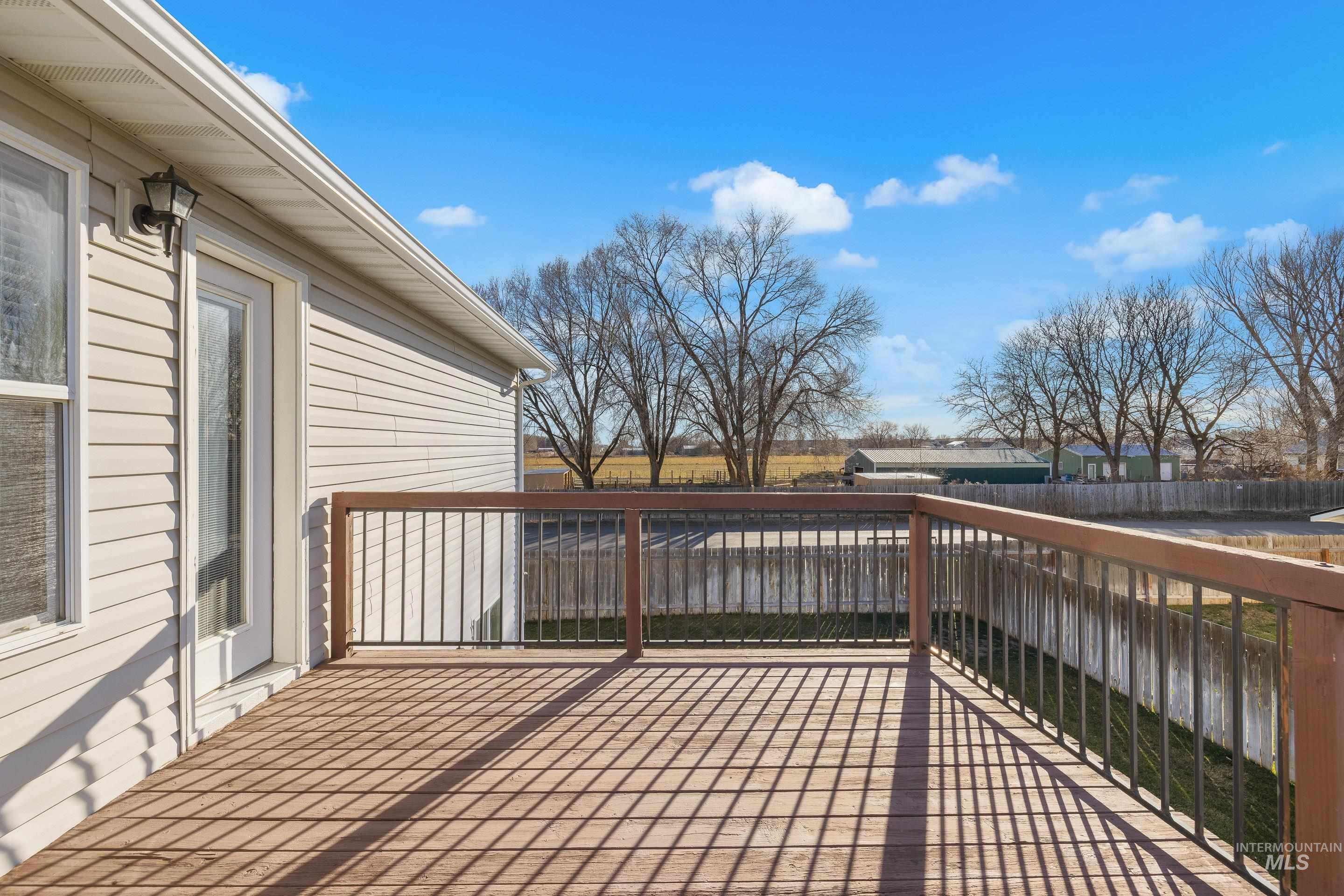 Wooden terrace featuring a fenced backyard