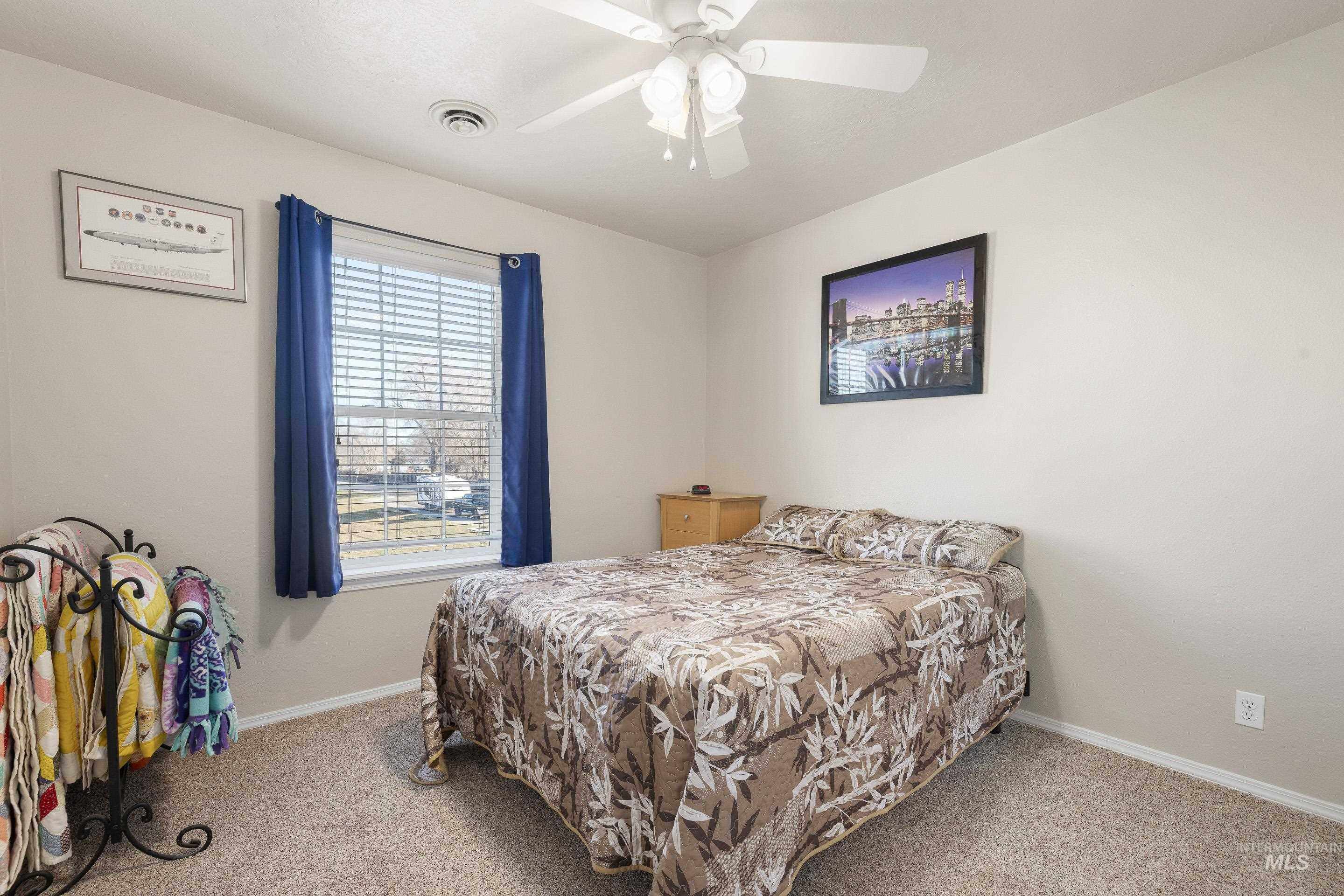 Bedroom featuring carpet flooring and a ceiling fan