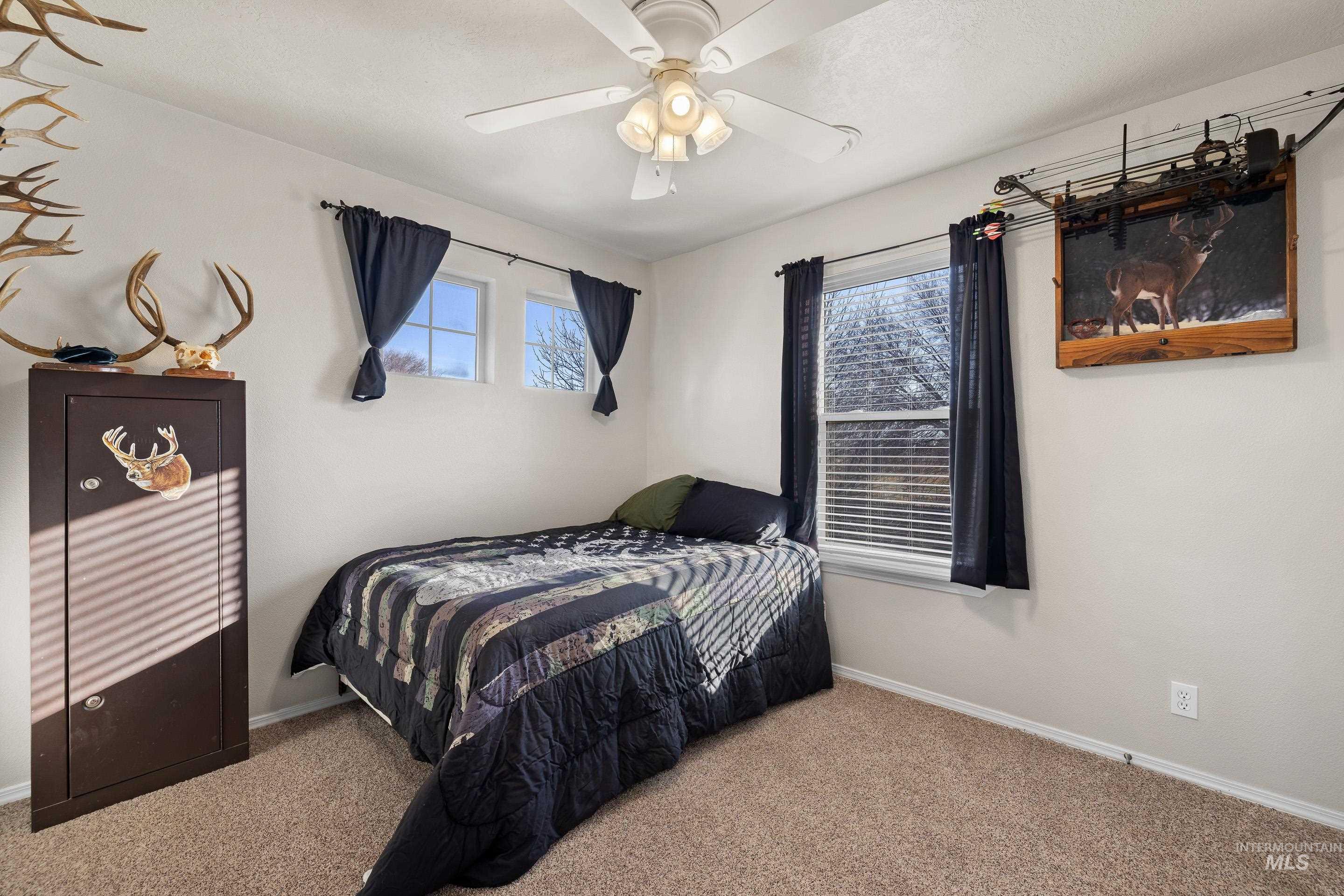 Bedroom featuring carpet floors and ceiling fan