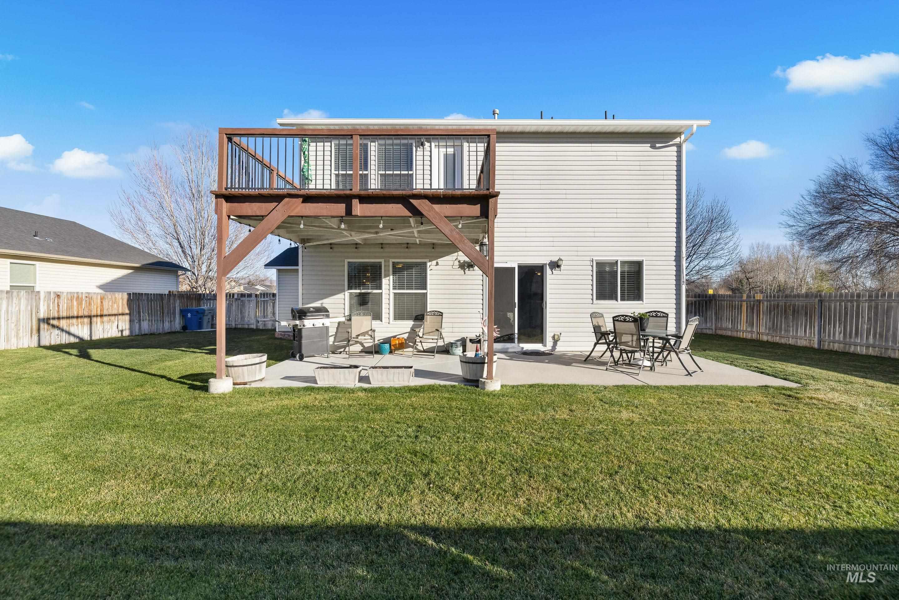 Back of property with a patio area and a fenced backyard