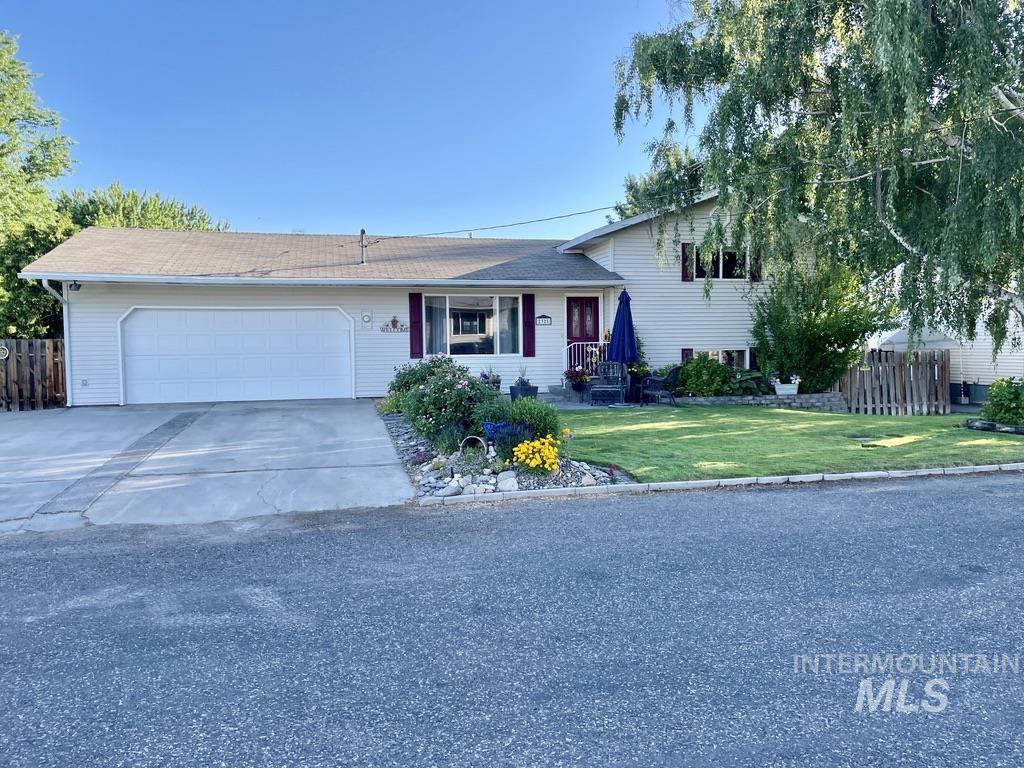 Tri-level home with concrete driveway and an attached garage