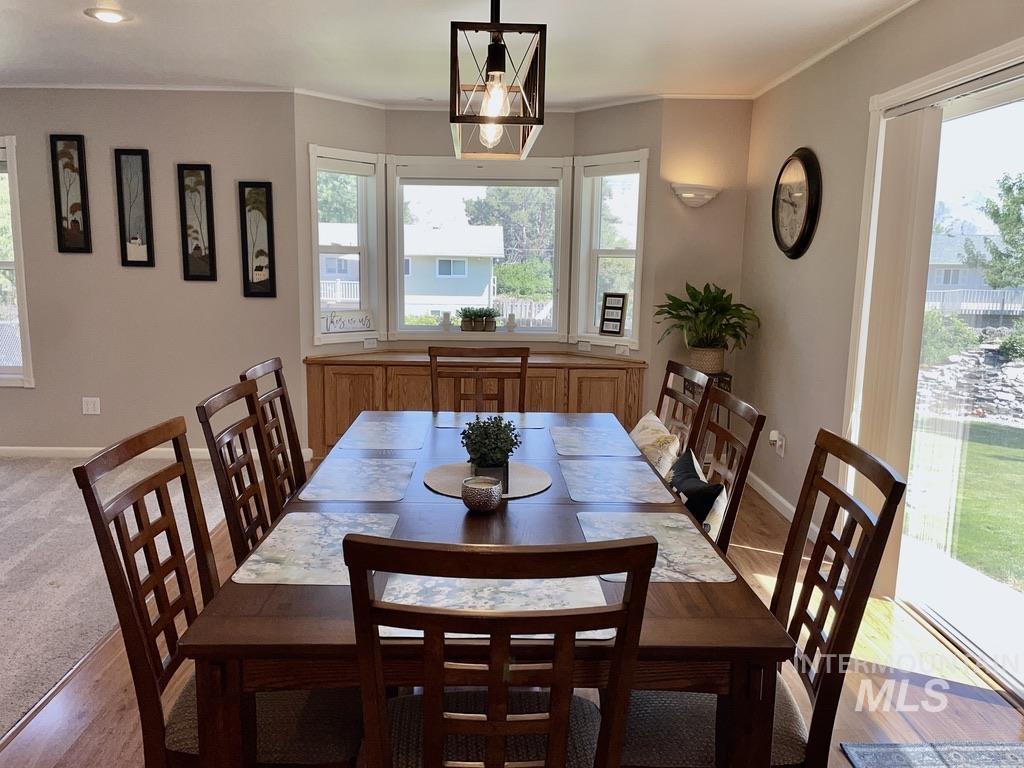 Dining area featuring healthy amount of natural light and crown molding