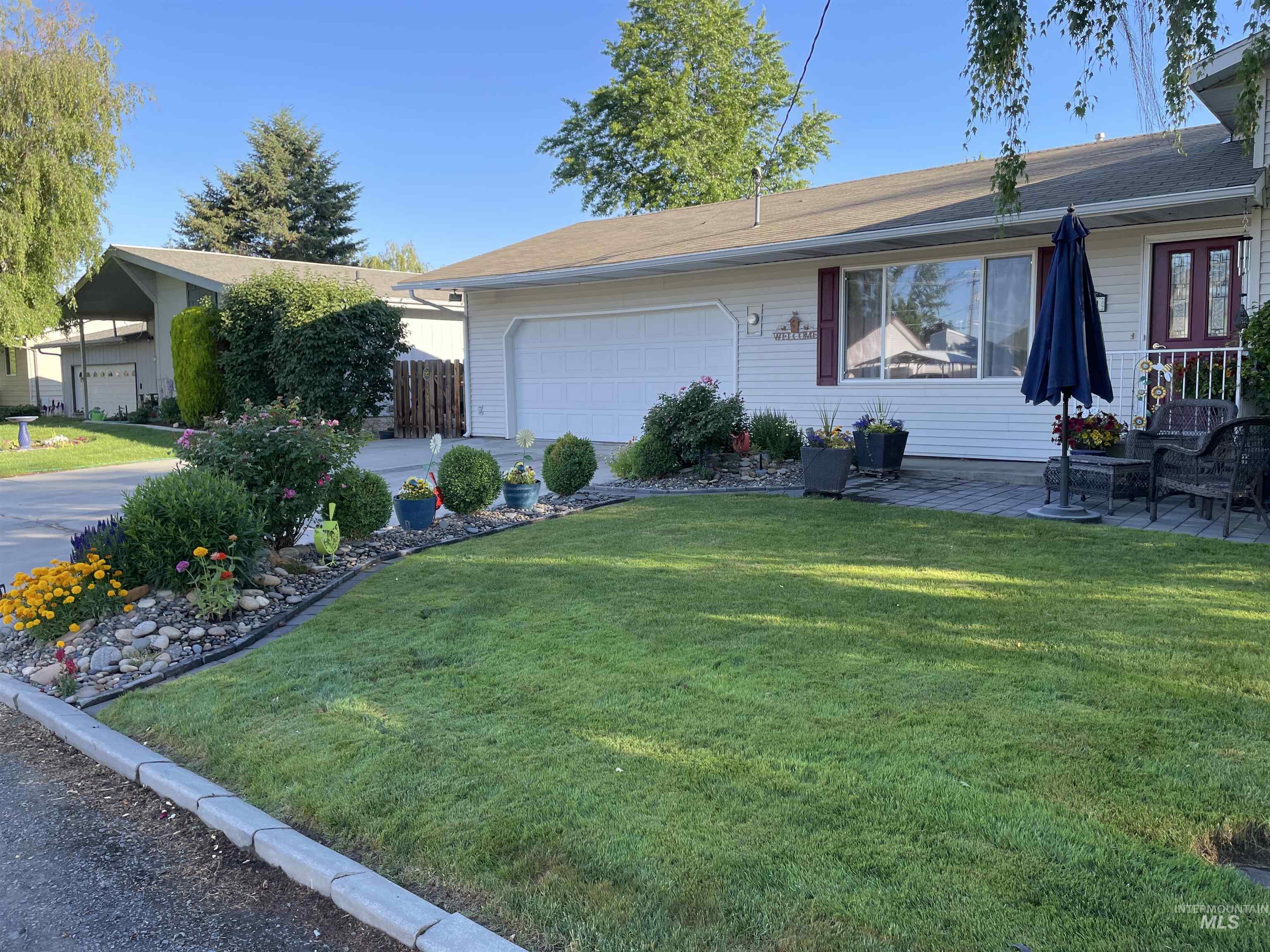 Ranch-style home with a front yard and an attached garage