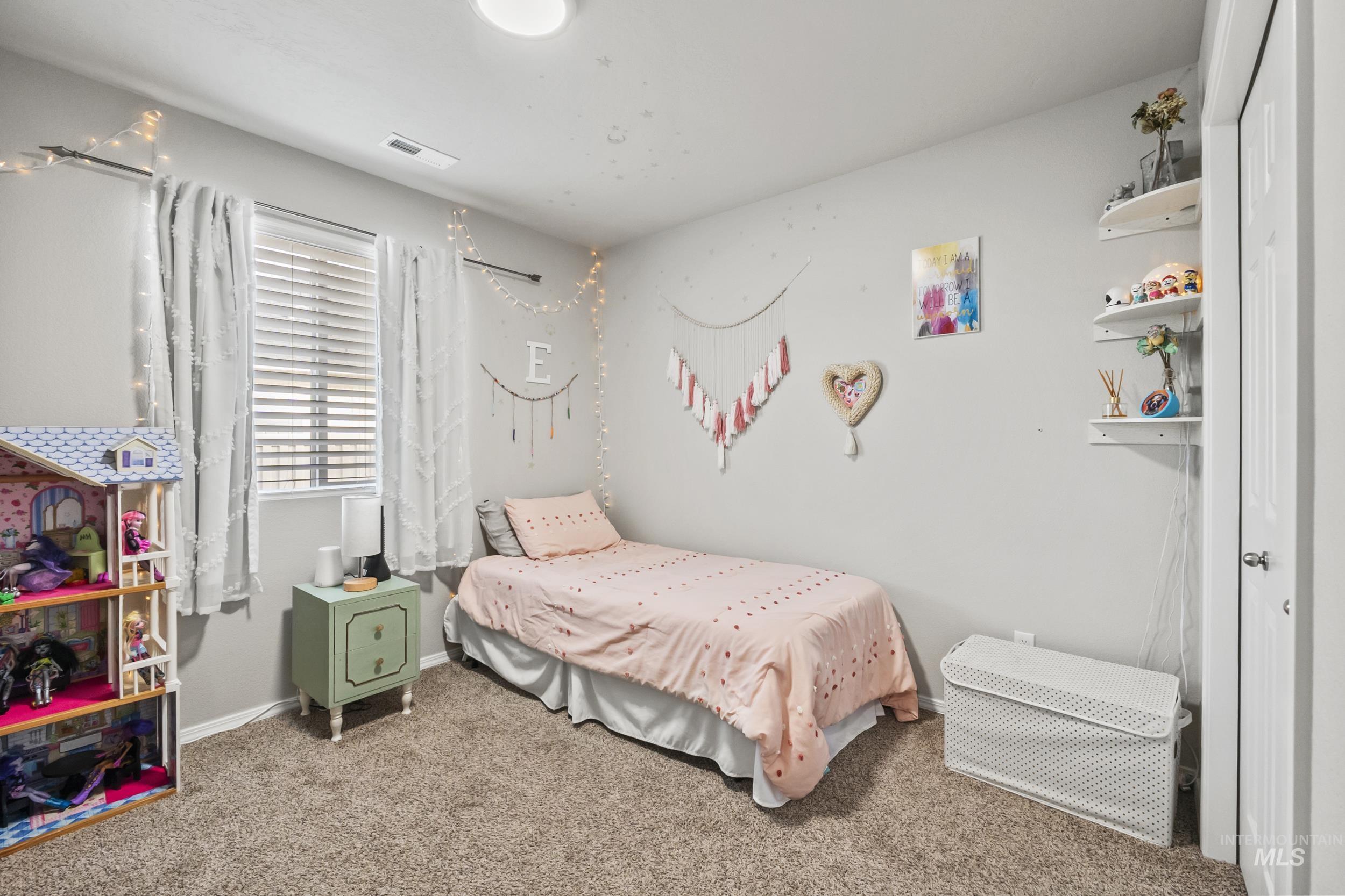 Bedroom featuring carpet flooring and baseboards
