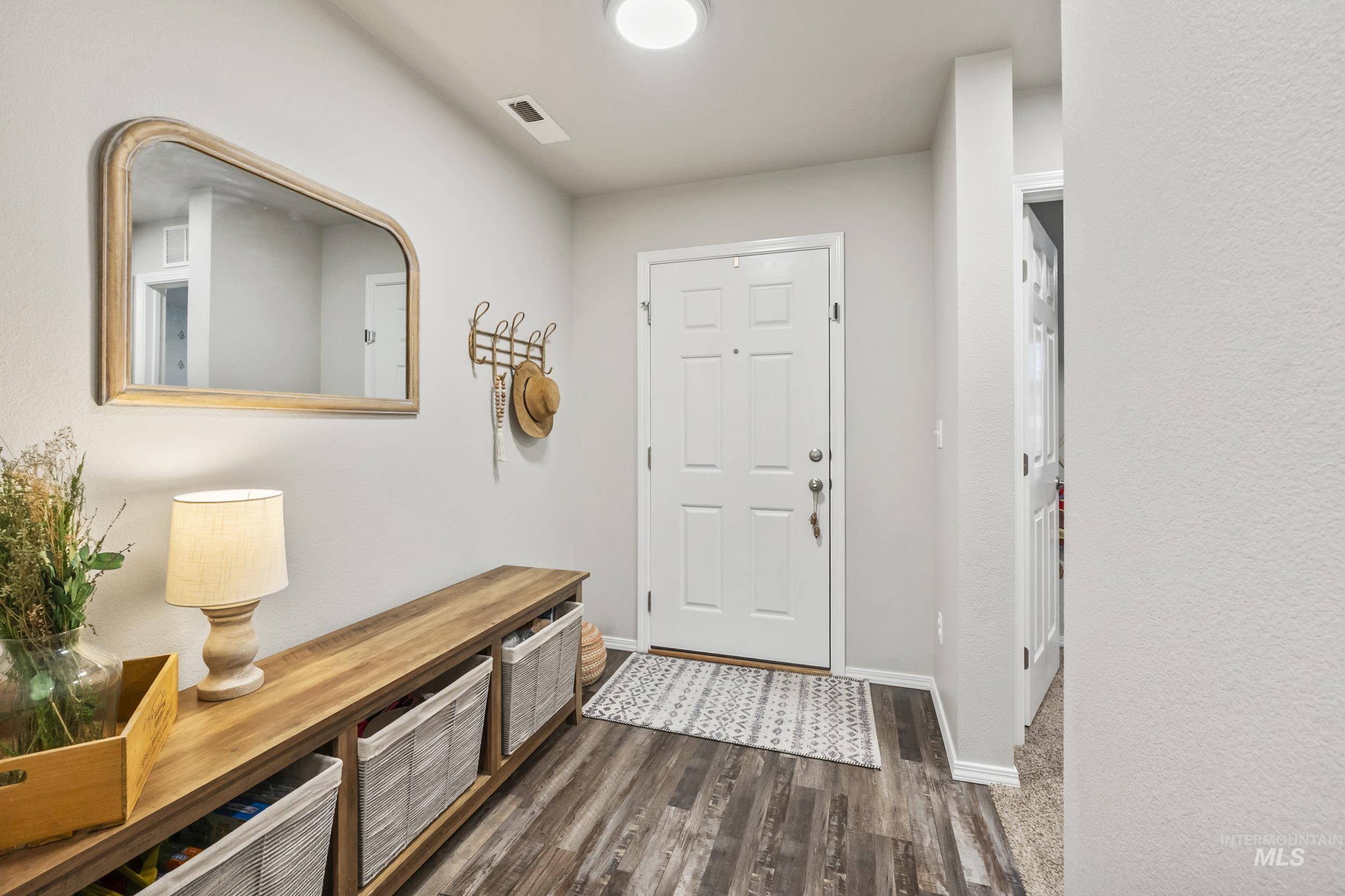 Foyer entrance with baseboards and dark wood finished floors