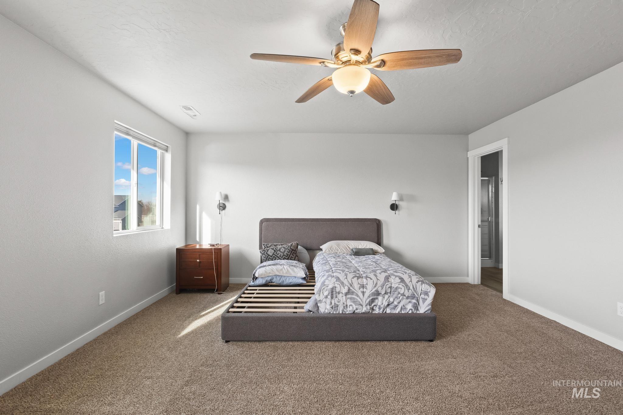 Bedroom with carpet flooring and a ceiling fan