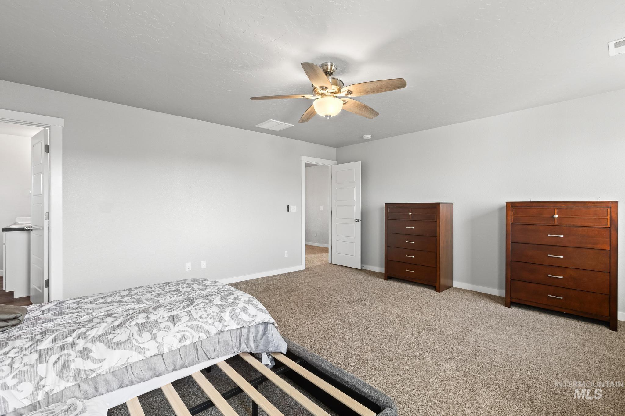 Bedroom featuring carpet and a ceiling fan