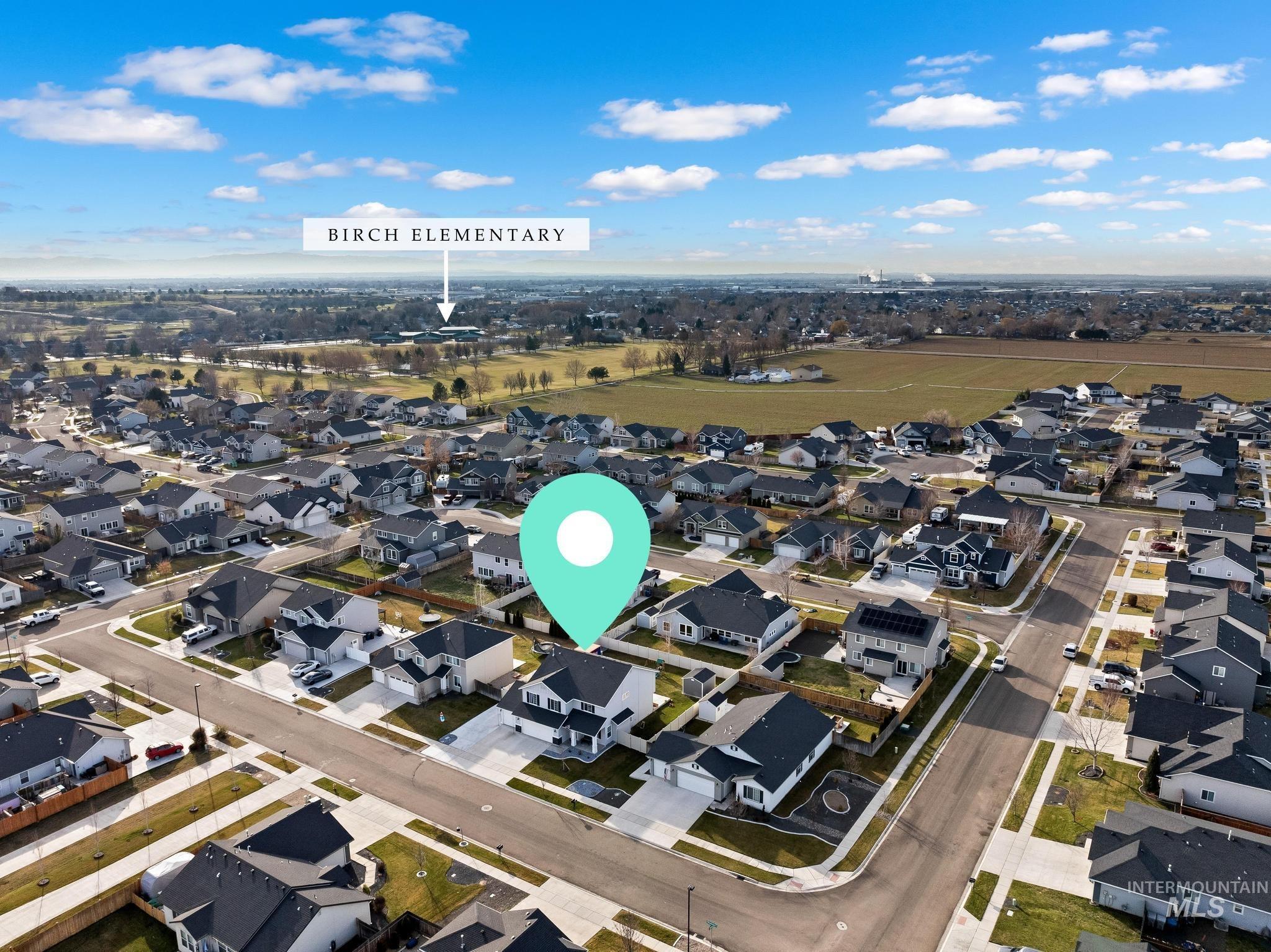 Aerial view of property's location featuring nearby suburban area