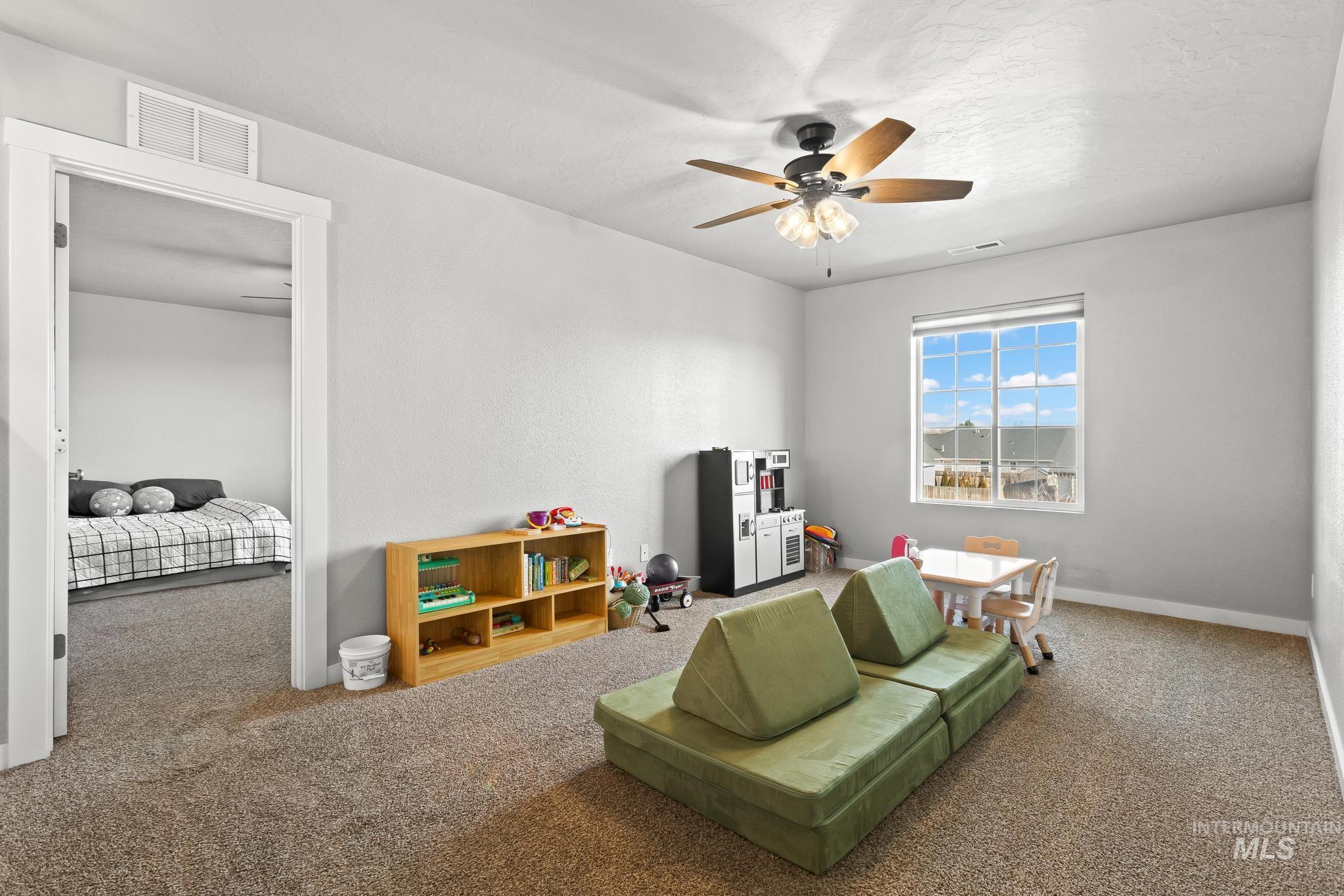 Rec room with carpet flooring and ceiling fan
