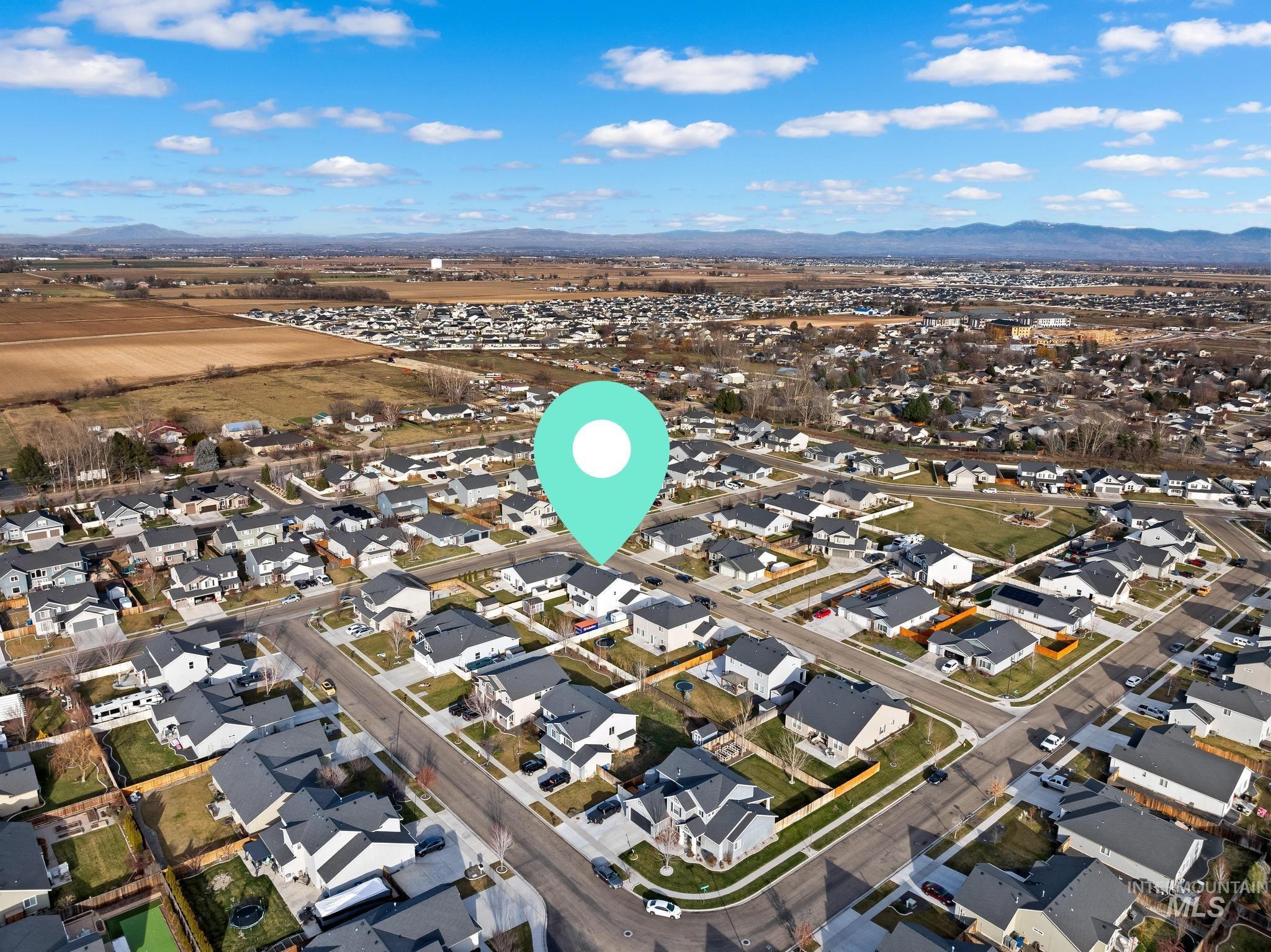 View of property location with a mountain backdrop and nearby suburban area