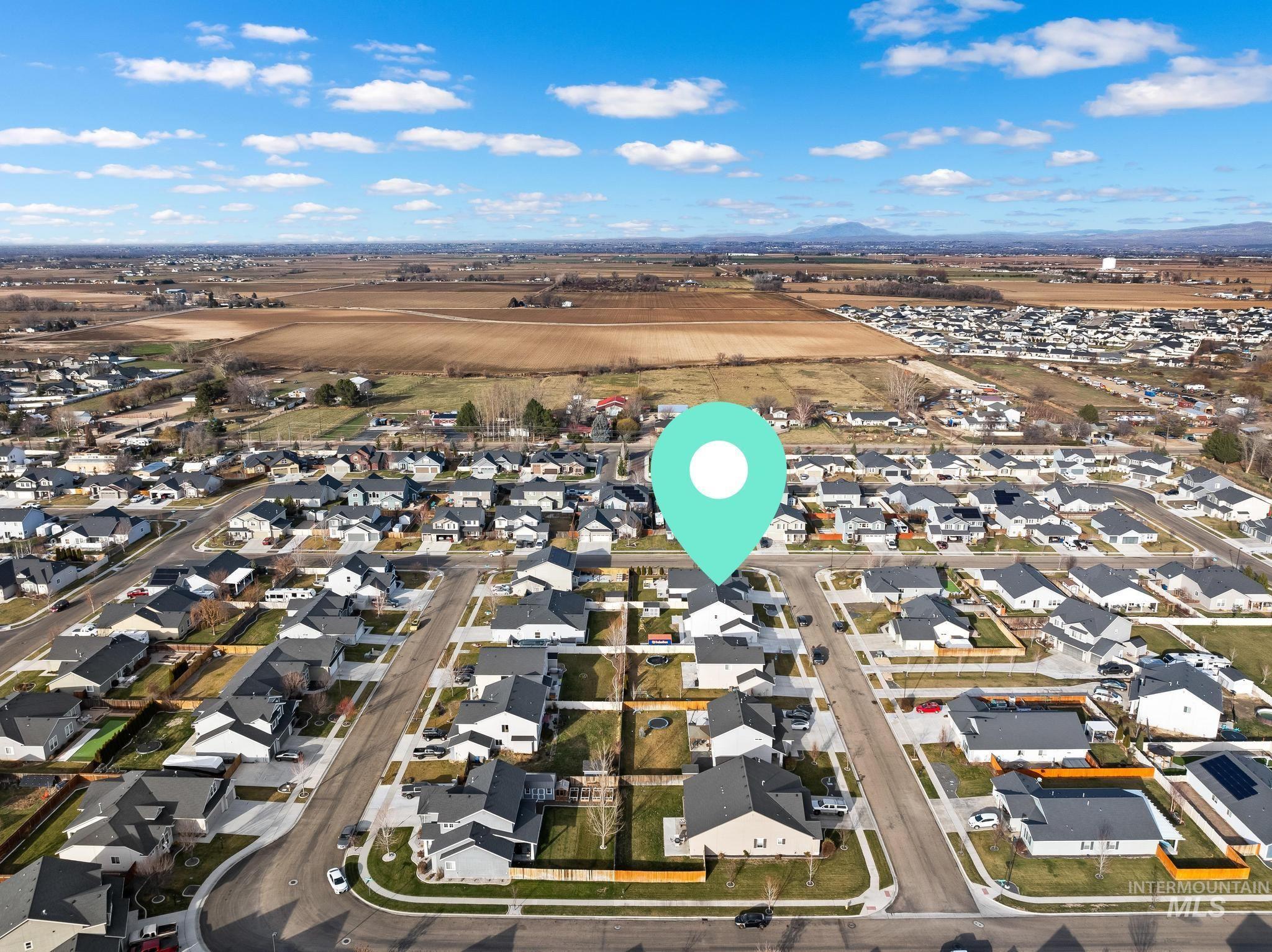 Aerial overview of property's location featuring nearby suburban area