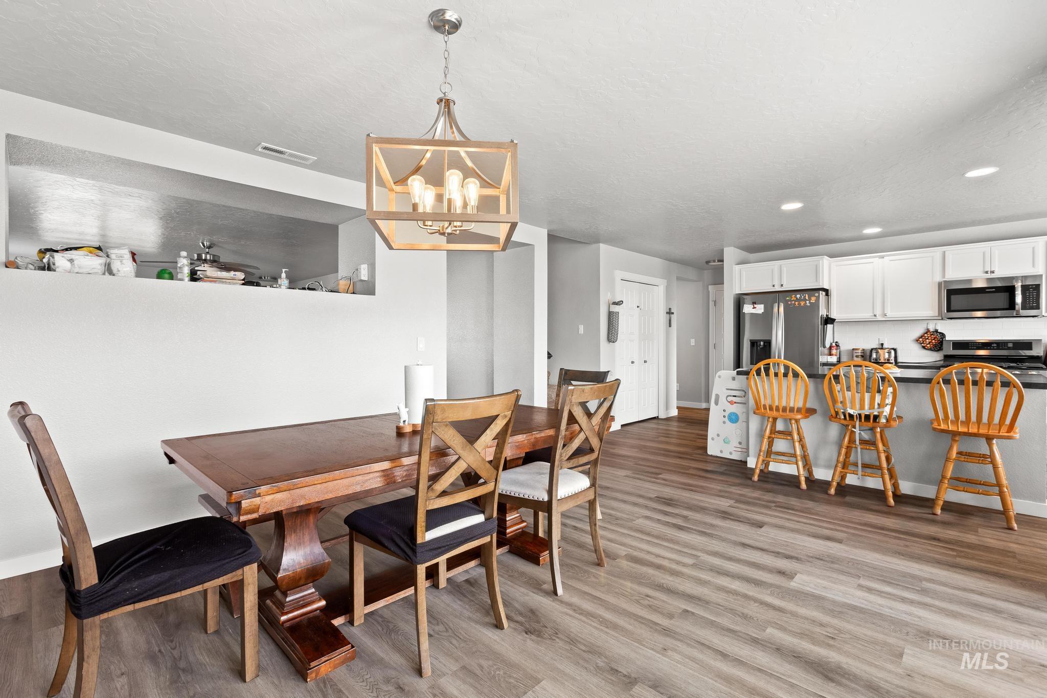 Dining area featuring recessed lighting, a chandelier, and light wood-style floors