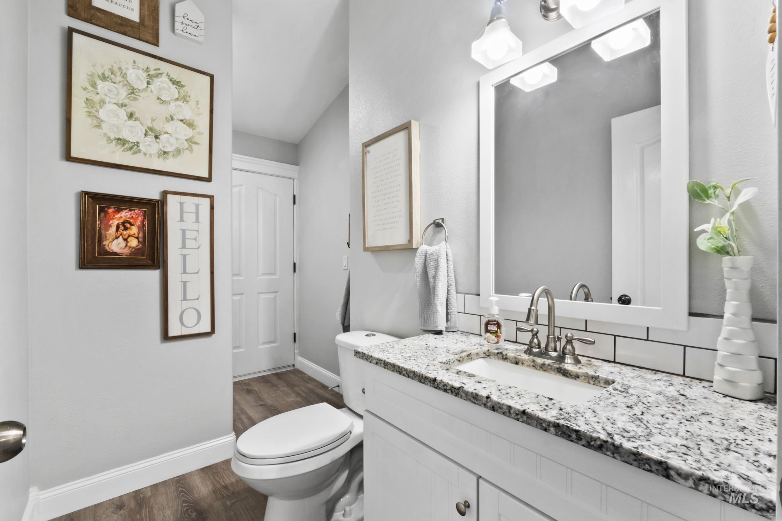 Bathroom with vanity and dark wood-type flooring