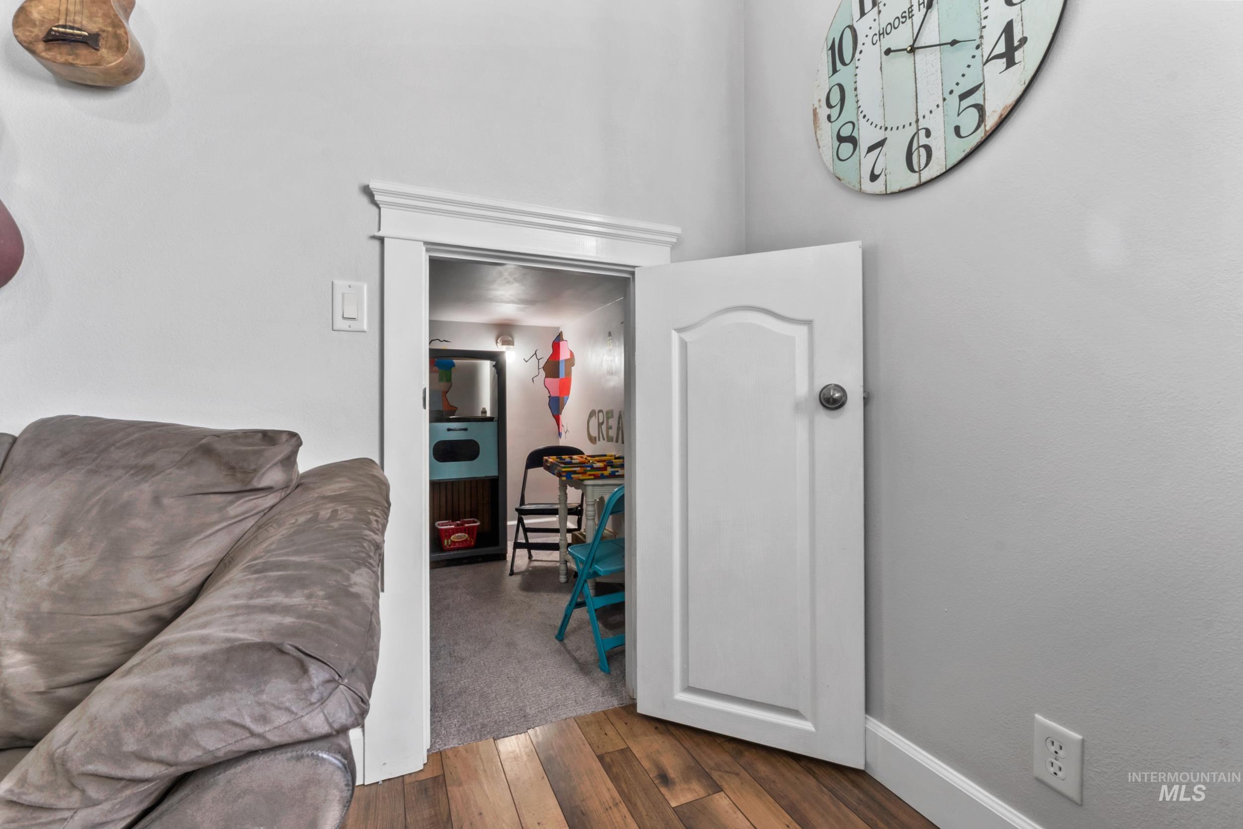 Hallway featuring wood-type flooring and baseboards