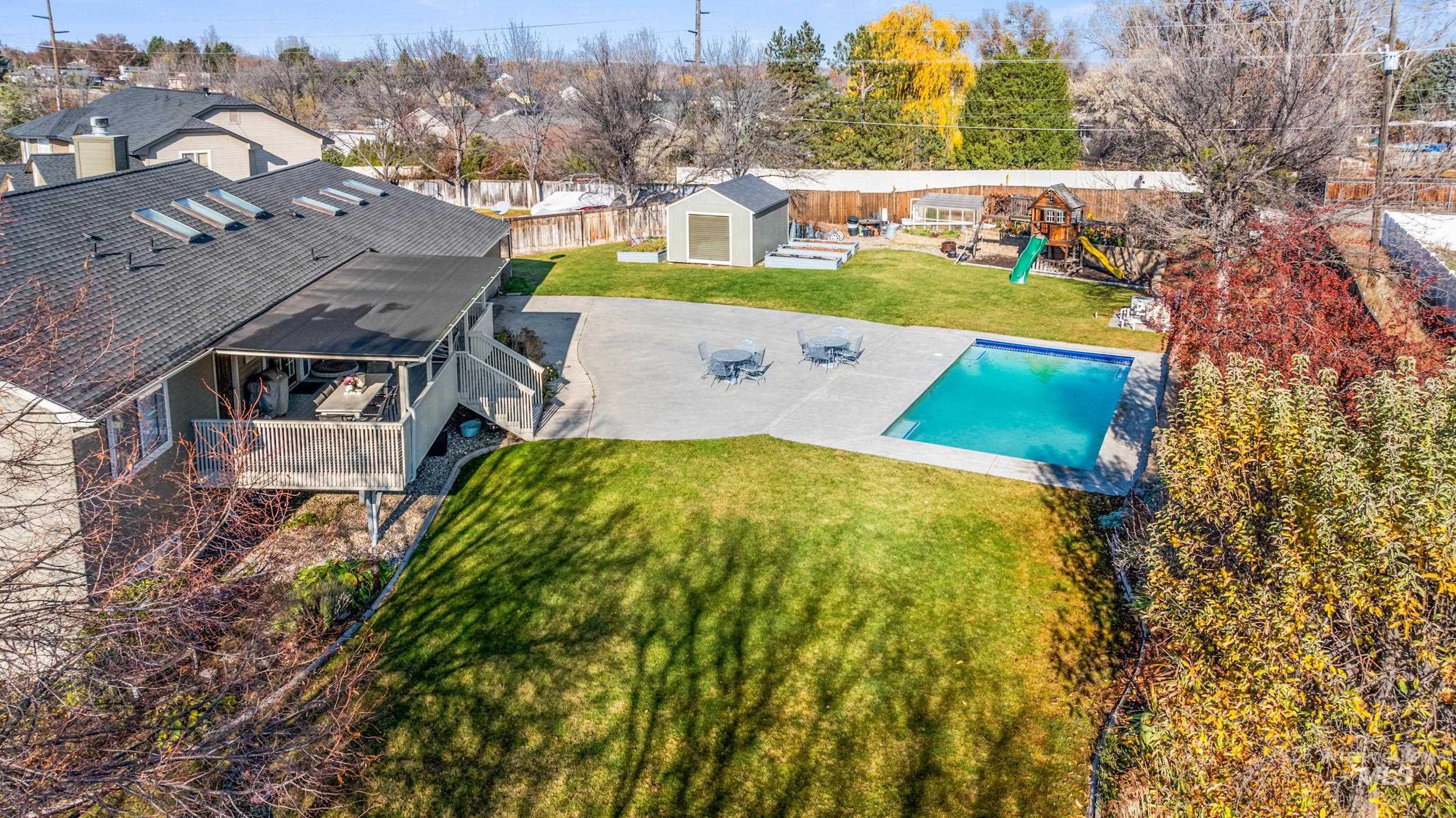 Aerial perspective of suburban area with a pool