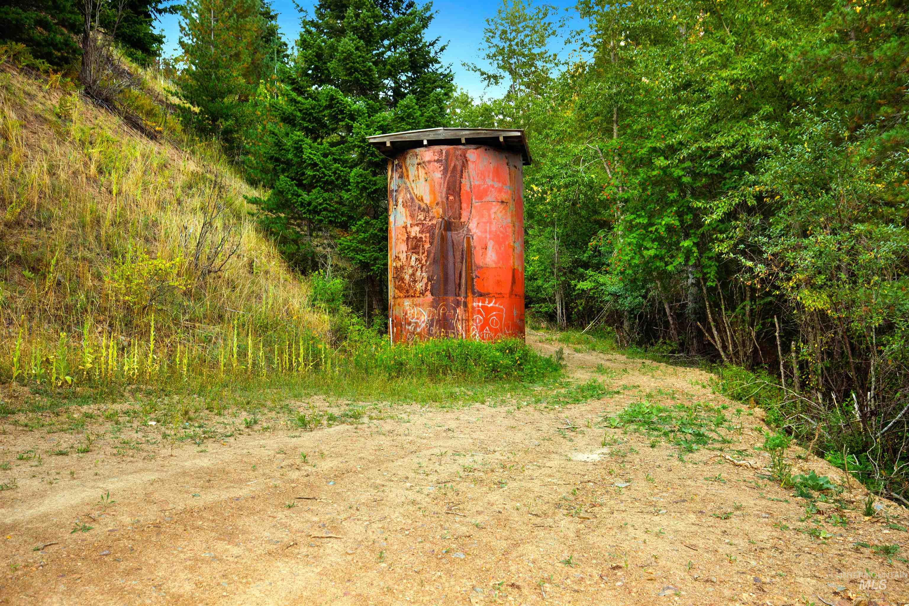 Access Rd. showing potable water tank serving adjacent community.  Community holds easement for tank and piping.