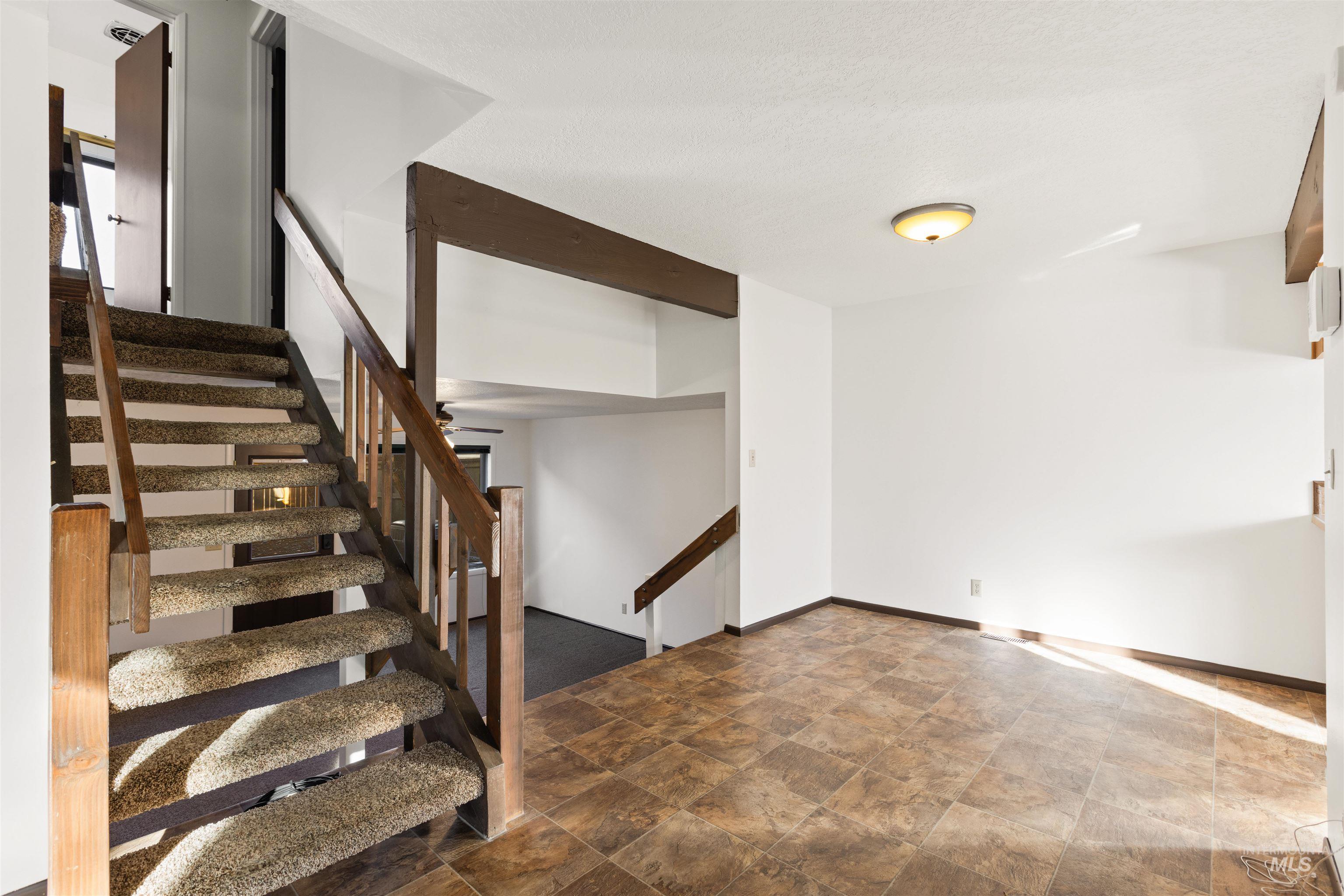 Stairs with stone finish flooring and baseboards