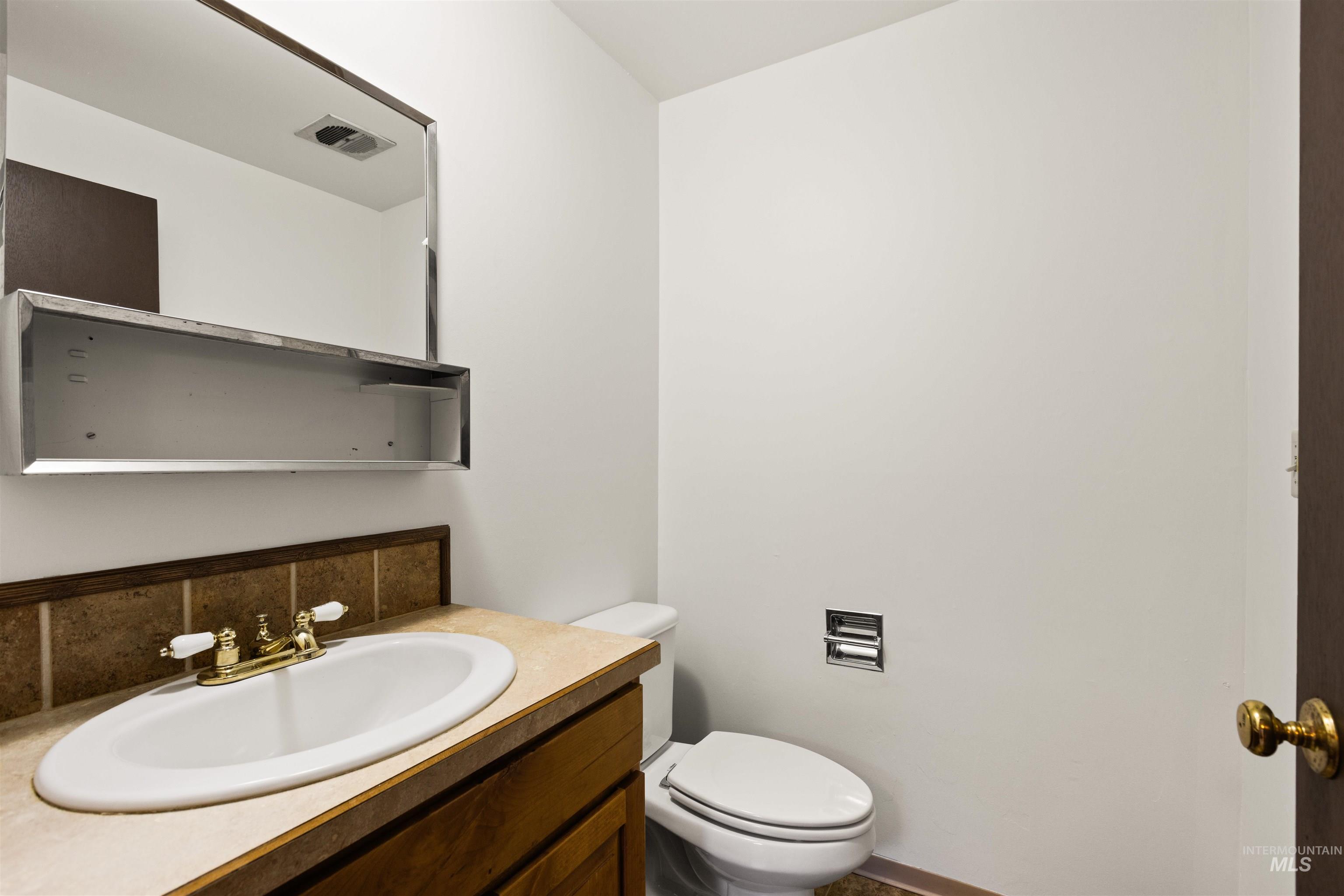 Bathroom with vanity and toilet