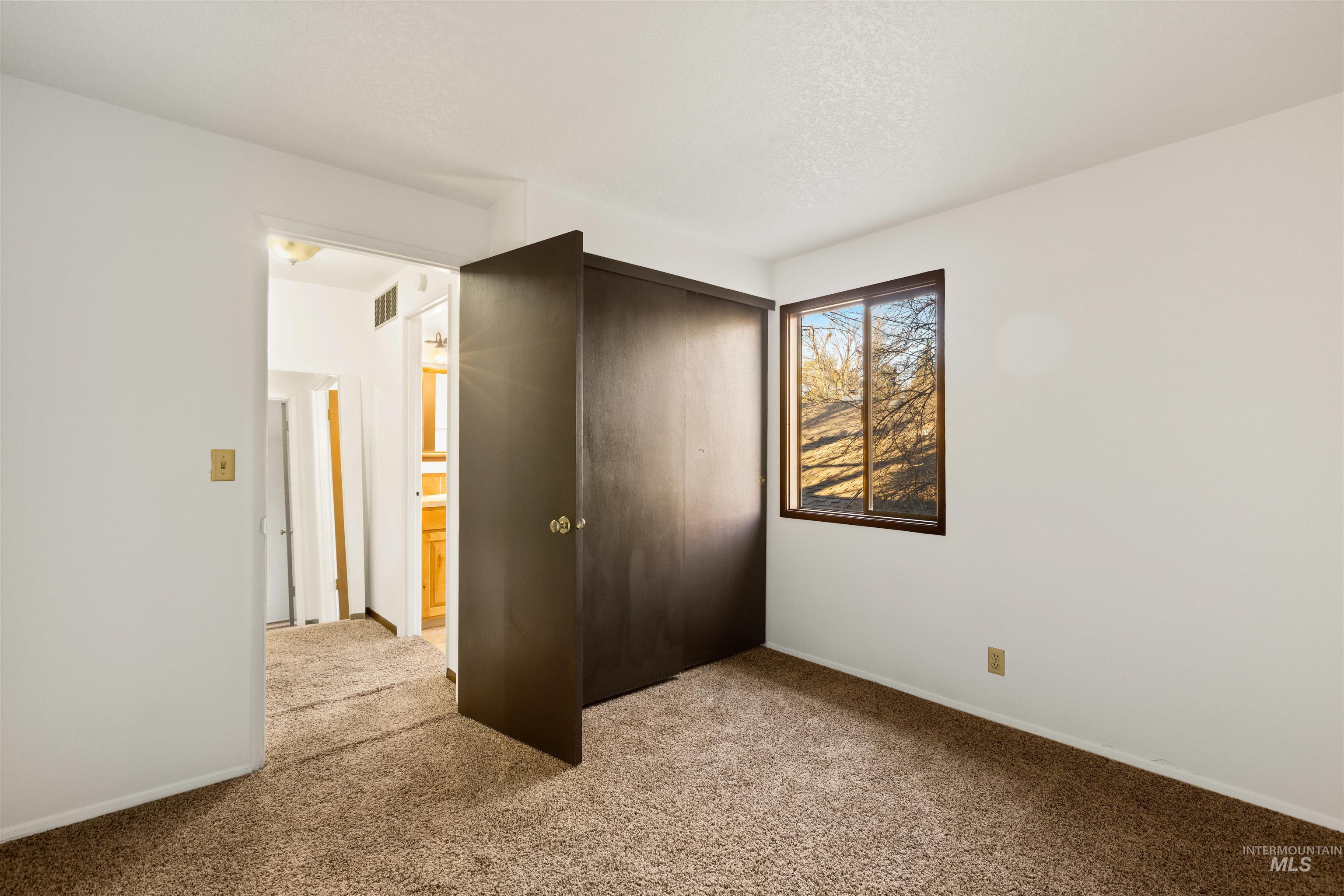Unfurnished bedroom with carpet floors and a closet